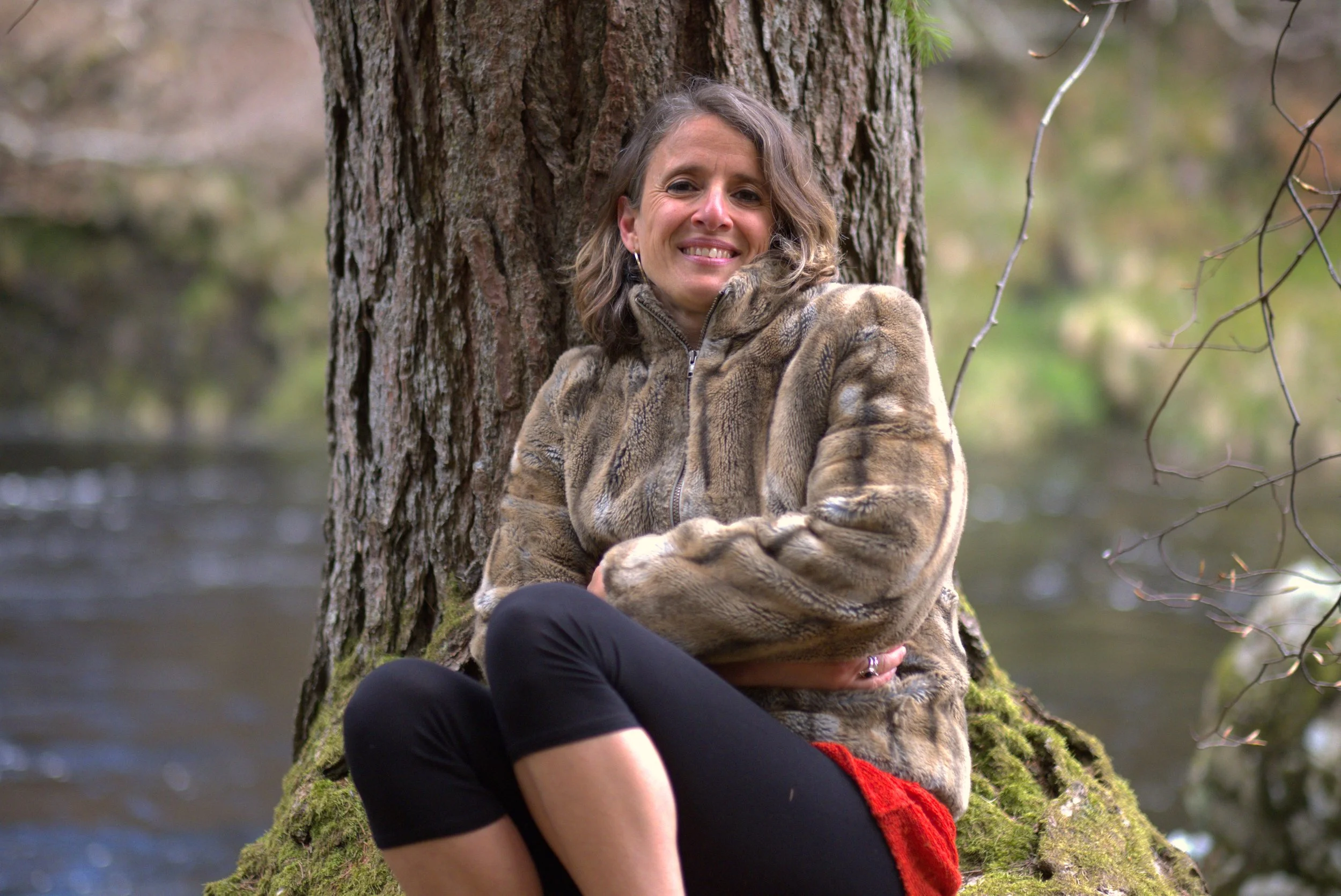 Findhorn River, woman meditating in the wilderness of Scotland
