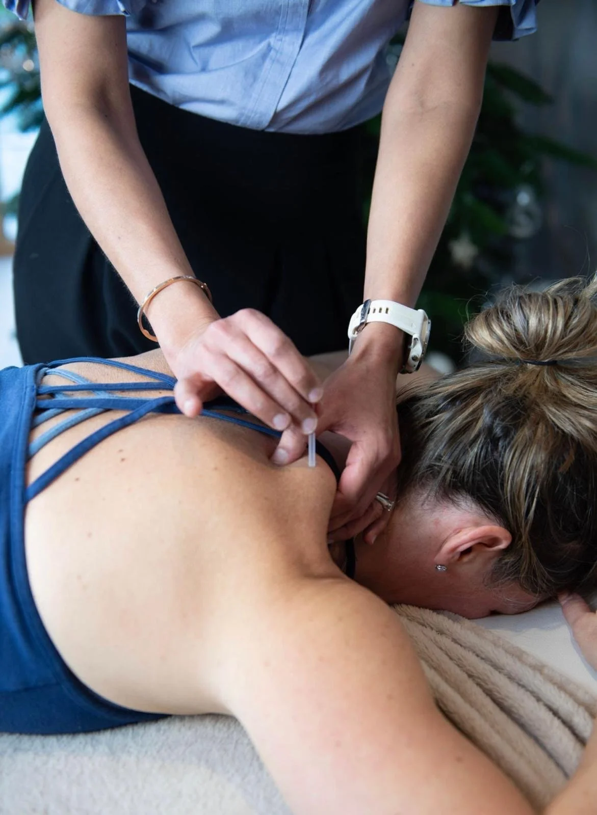 A person receiving an injection in their upper arm by a healthcare worker.
