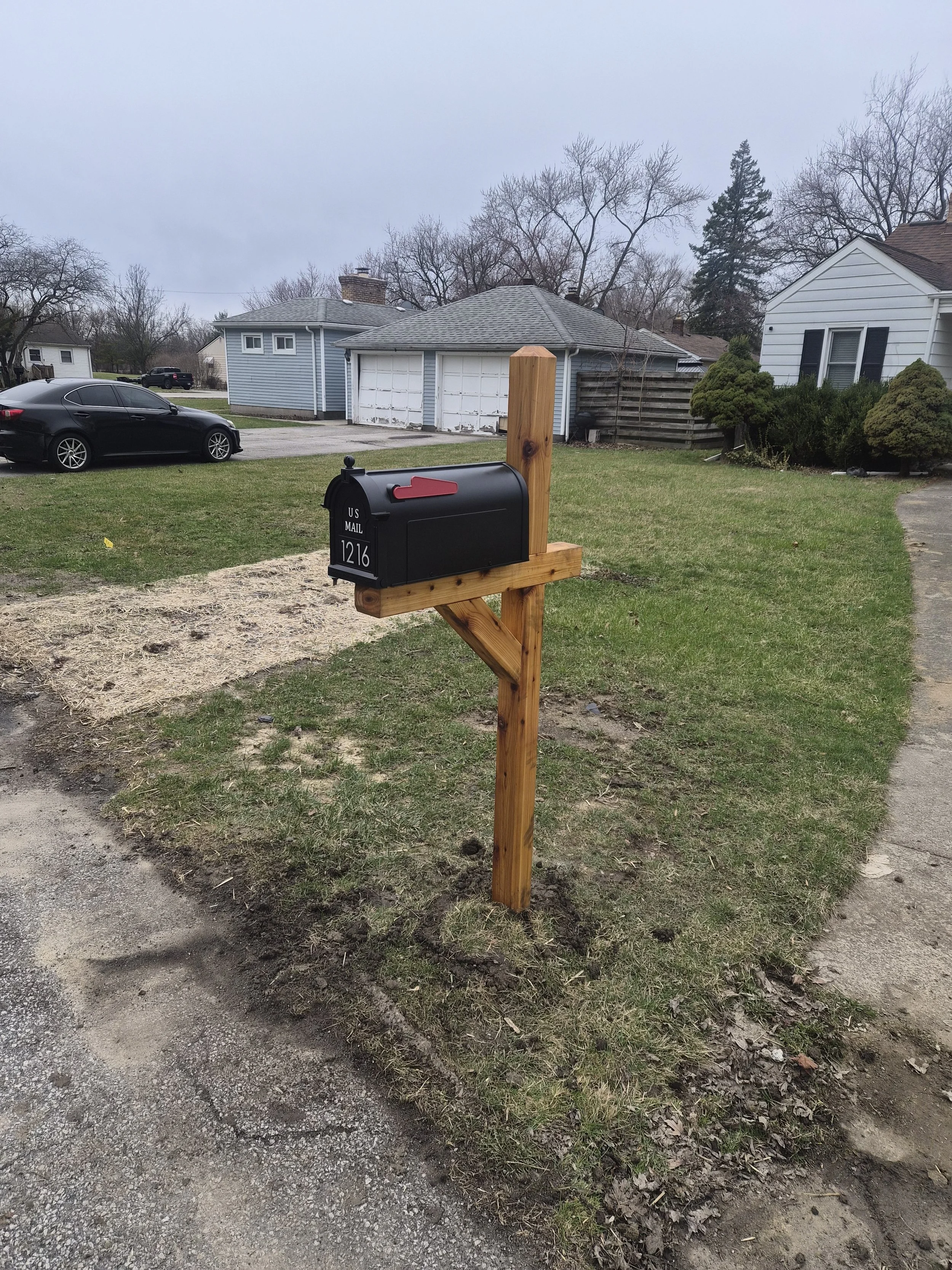 Custom cedar mailbox post installation with black mailbox and modern address numbers by Spartan Cityscape in Northwest Indiana