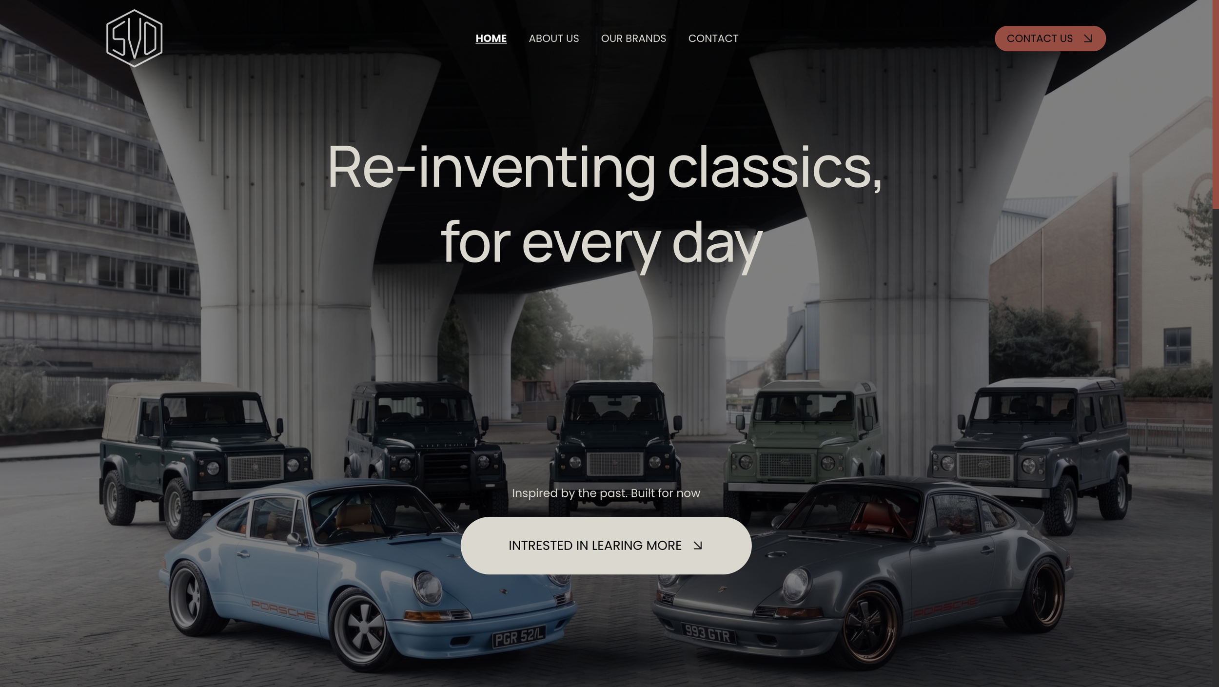 Website homepage featuring luxury cars, including classic Porsche and vintage Land Rover vehicles, under a modern urban bridge with a cityscape background, and a black top navigation bar with menu options and a red 'Contact Us' button.