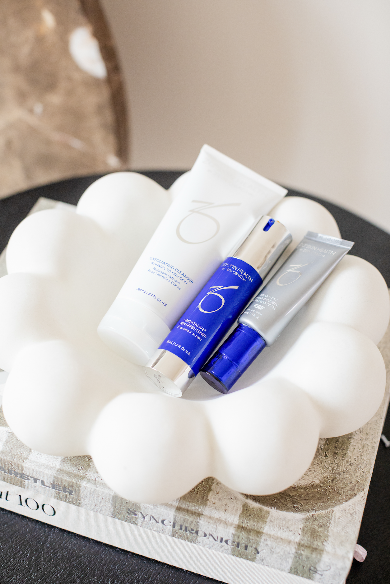 Medical-grade skincare products placed inside a white ceramic tray.