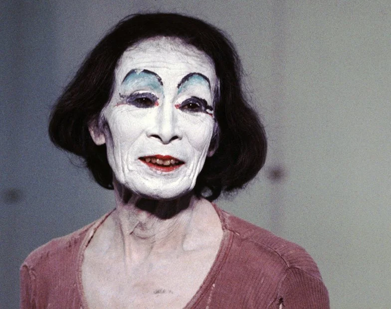 Kazuo Ohno in heavy makeup dressed as a woman