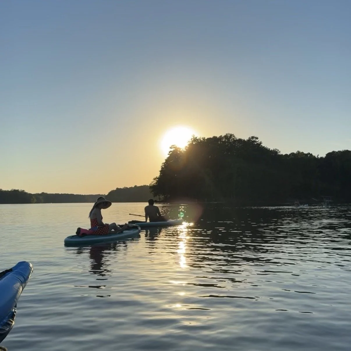 Paddleboarder at sunrise on Mountain Island Lake before SUP yoga