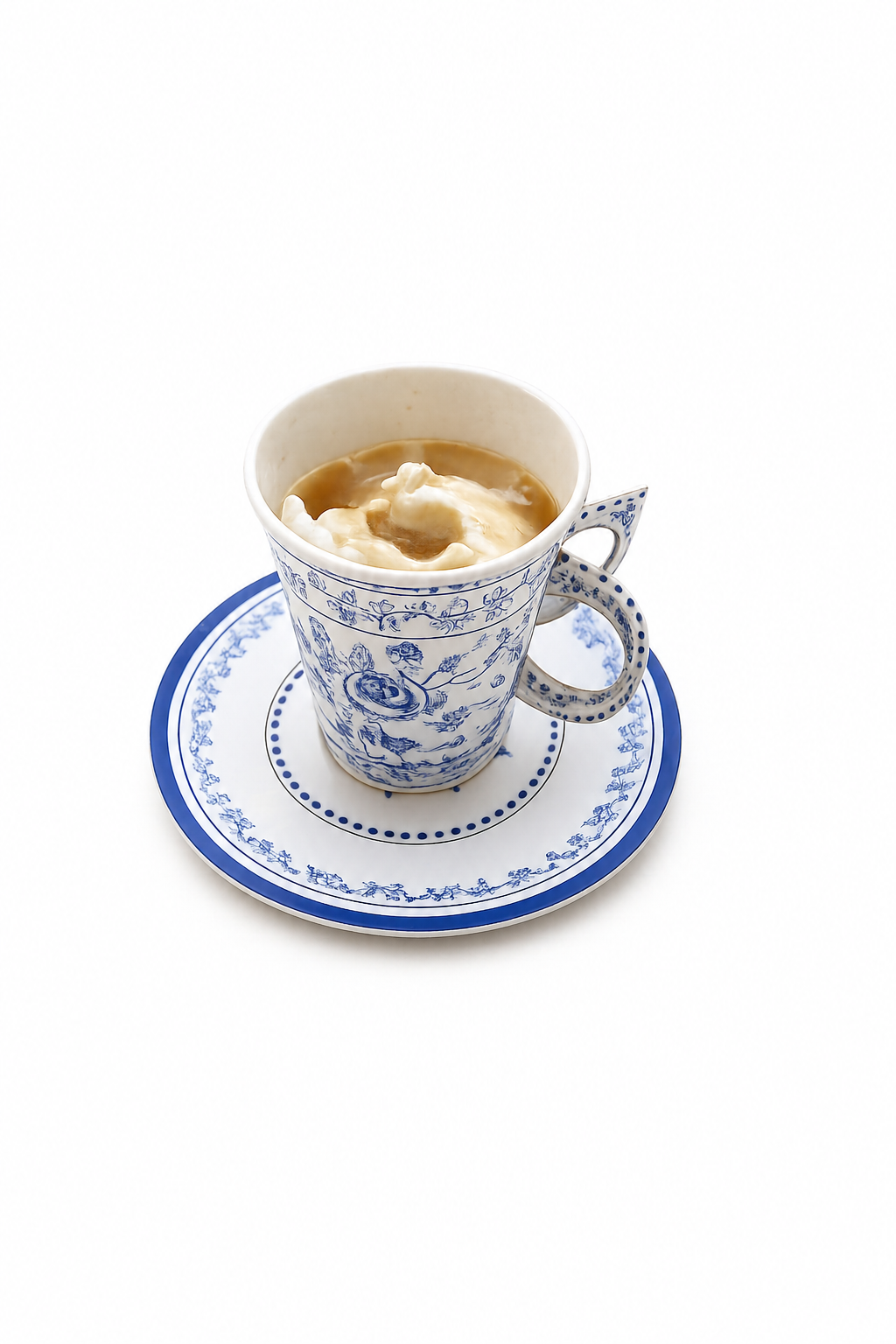 A ceramic cup filled with coffee topped with whipped cream on a matching blue and white saucer.