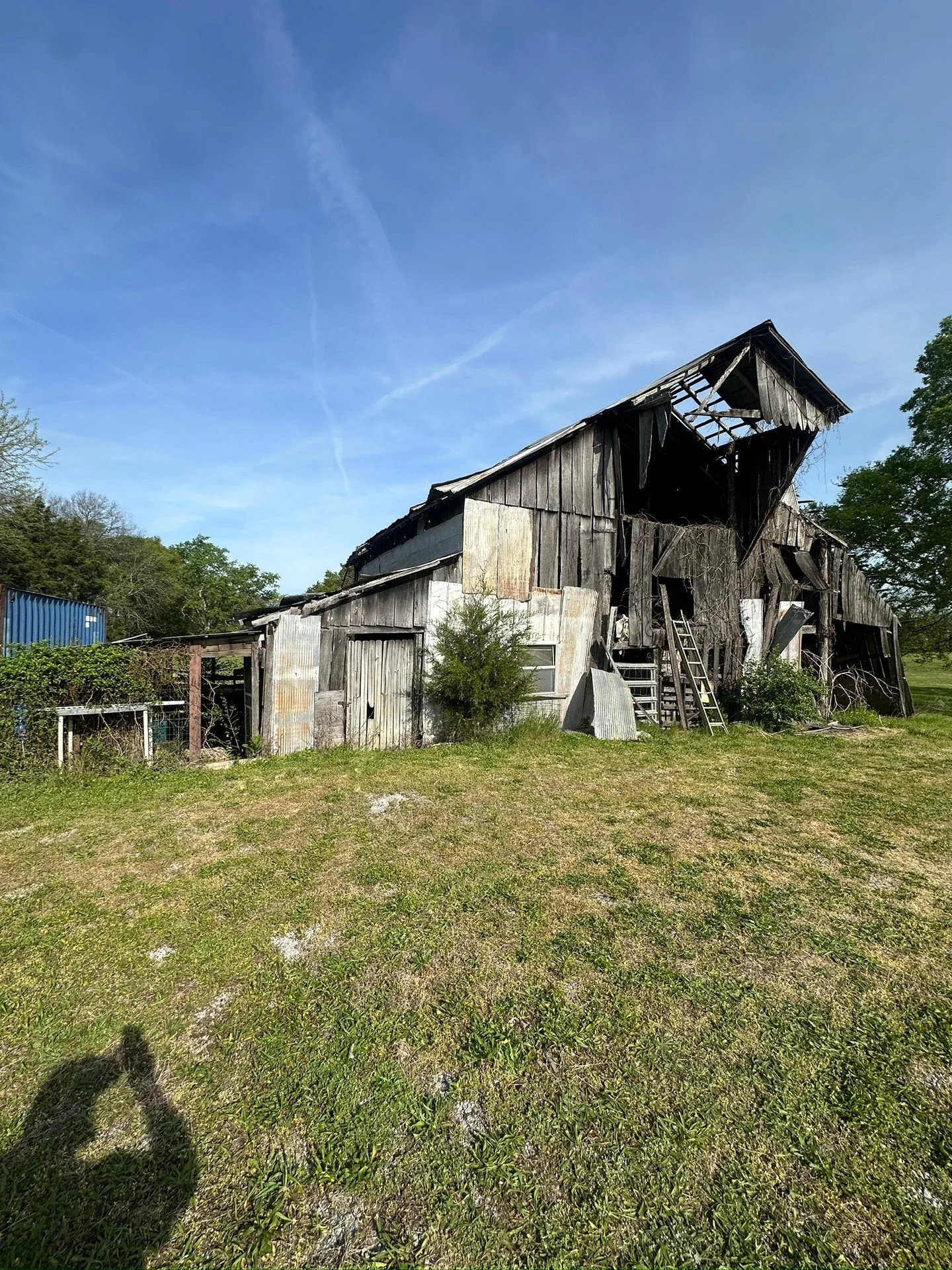 Some jobs start with a phone call and a photo like this. Owner needed this barn gone and the lot cleared. We loaded up and headed out.