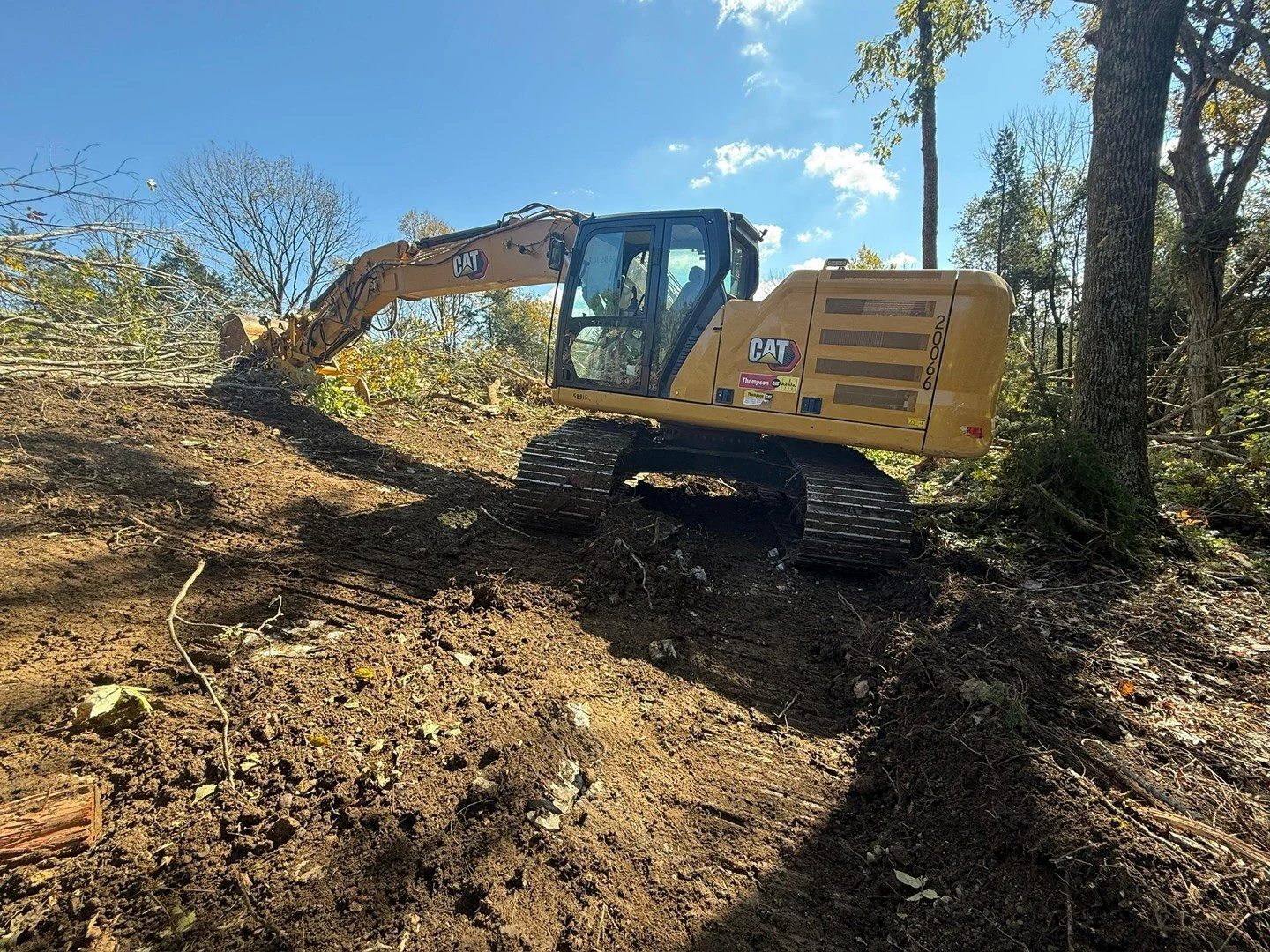 Slope work in Middle Tennessee. Trees come down, grade goes in, and the land starts looking like something you can build on.