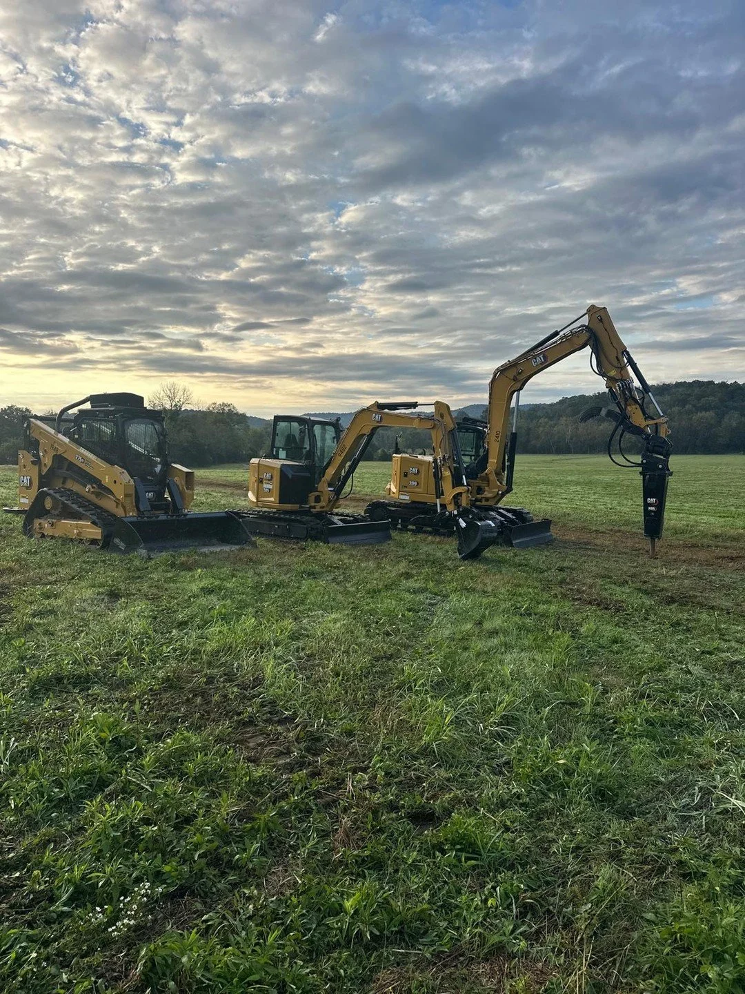 Three machines lined up before the day starts. Each one has a job. Right iron, right work.