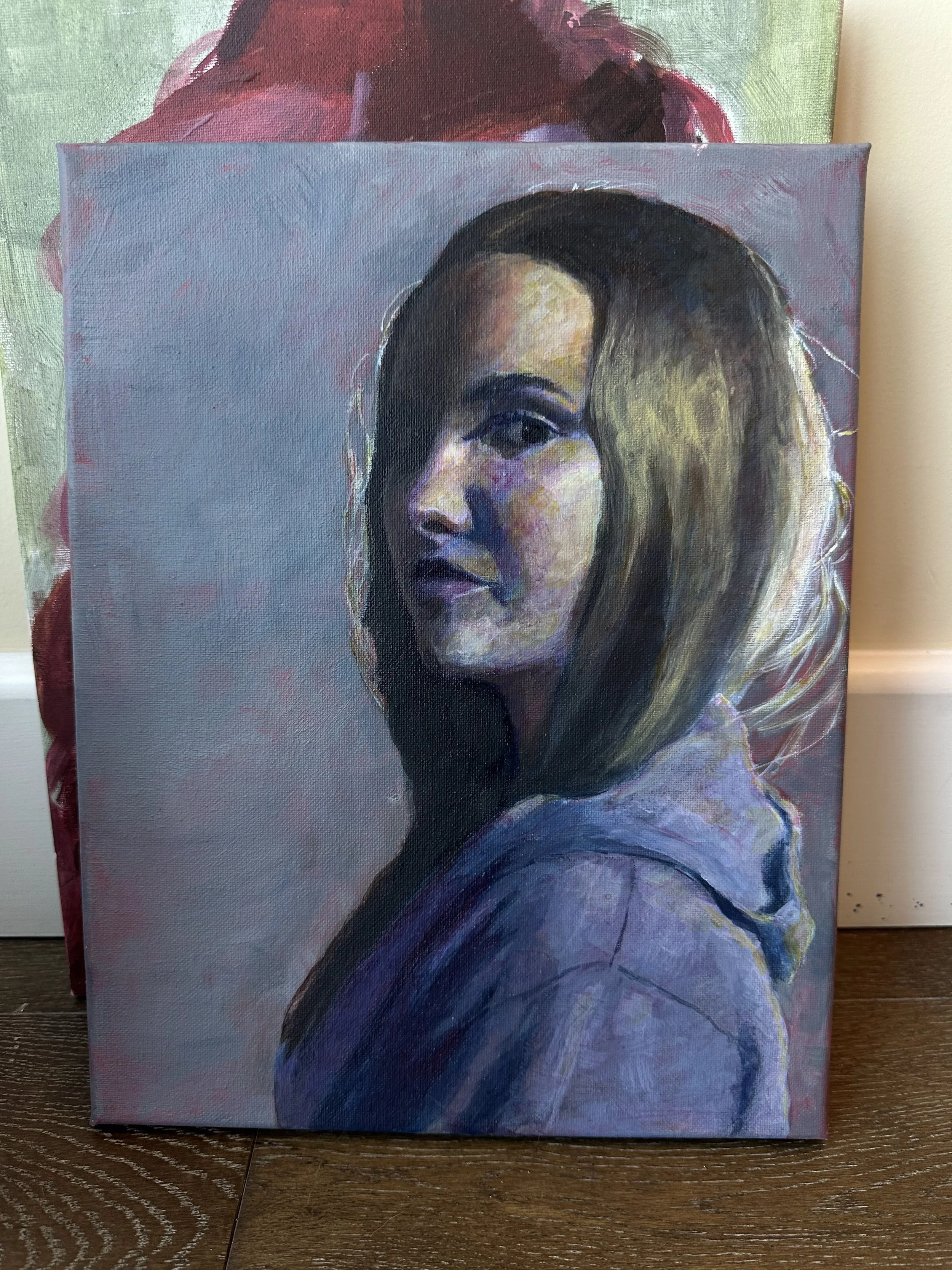 A portrait painting of a young woman with shoulder-length brown hair, wearing a hoodie, with lighting emphasizing the left side of her face and hair.