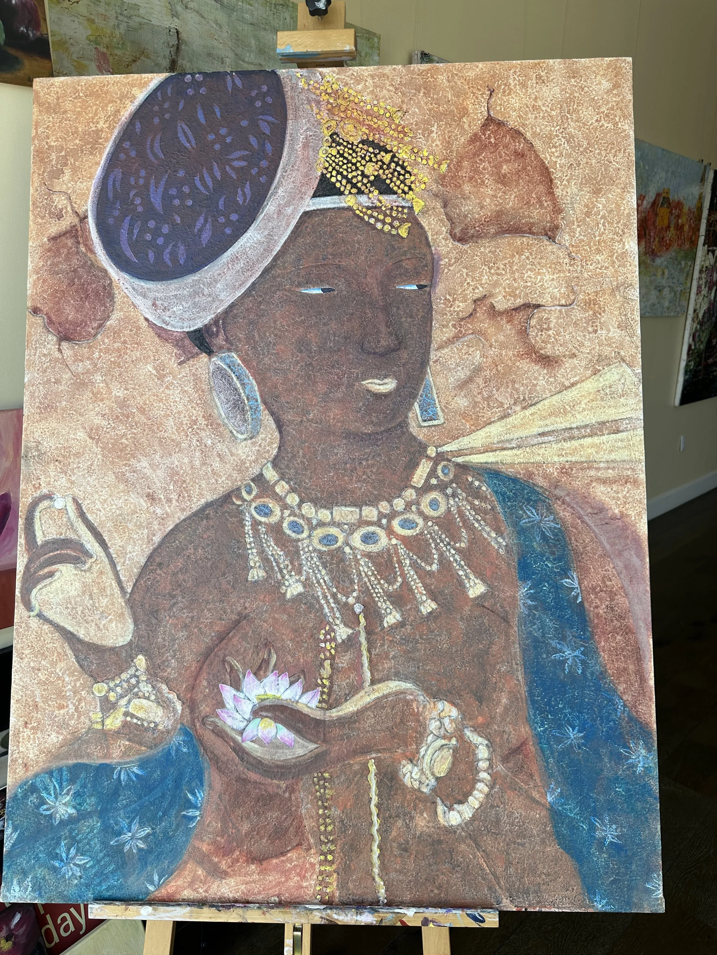 A painting of a woman with brown skin, adorned with jewelry and a large headwrap, holding a lotus flower in her hand.