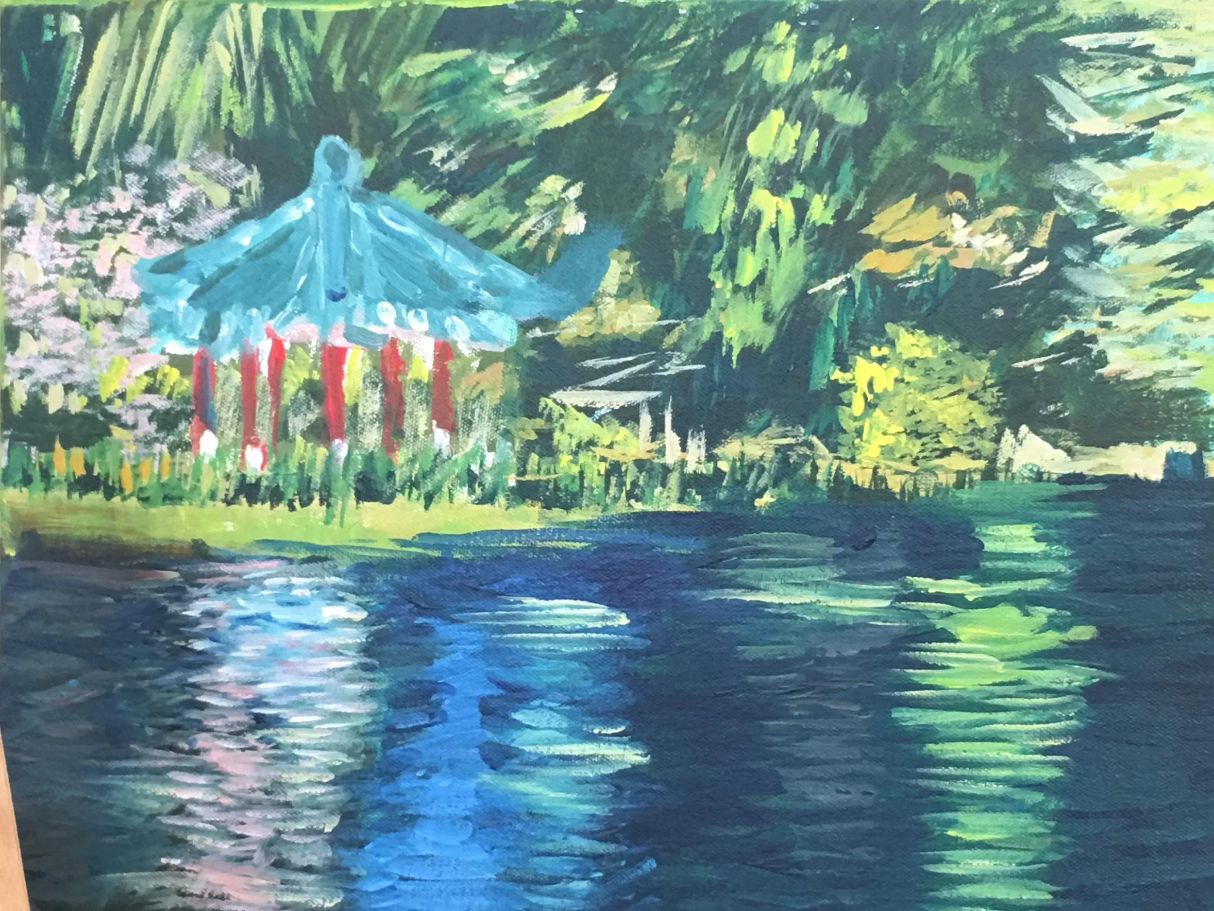 A colorful impressionist-style painting of a lakeside scene with a blue pagoda-style structure surrounded by lush green trees, with reflections of the sky and trees on the water.