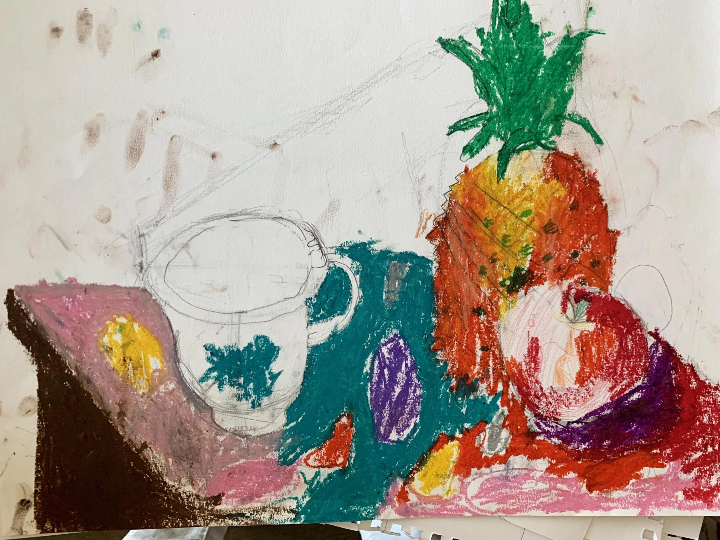 Child's colorful drawing of a still life arrangement, including a pineapple, an apple, a cup with a flower, and a spoon, painted with crayons or colored pencils.