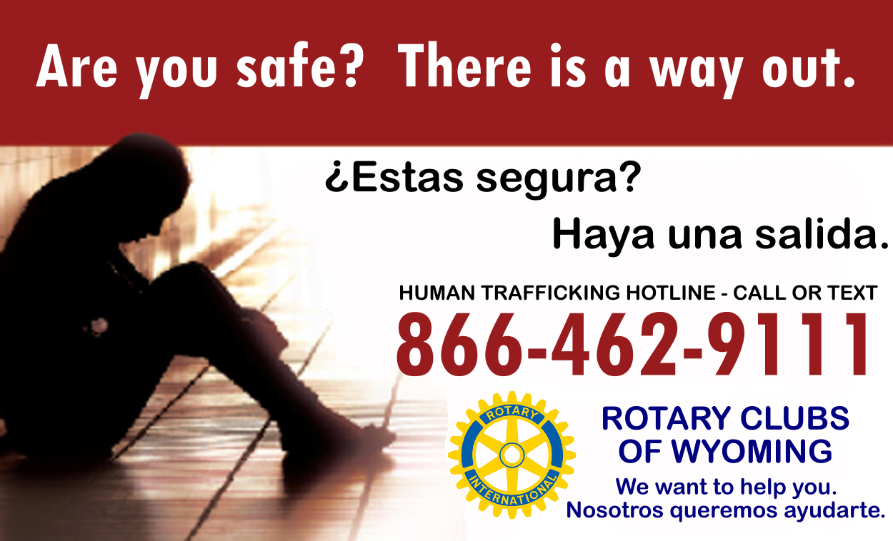 Silhouette of a person sitting on a bench in a shelter, with text about human trafficking hotline and help services, including a phone number and Rotary Club logo.