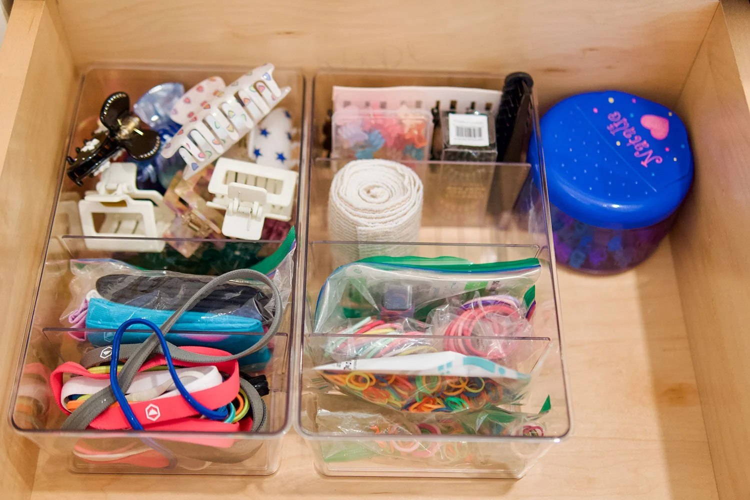 Organization drawer with hair accessories, clips, bands, and a blue container with a 'Notes' label.
