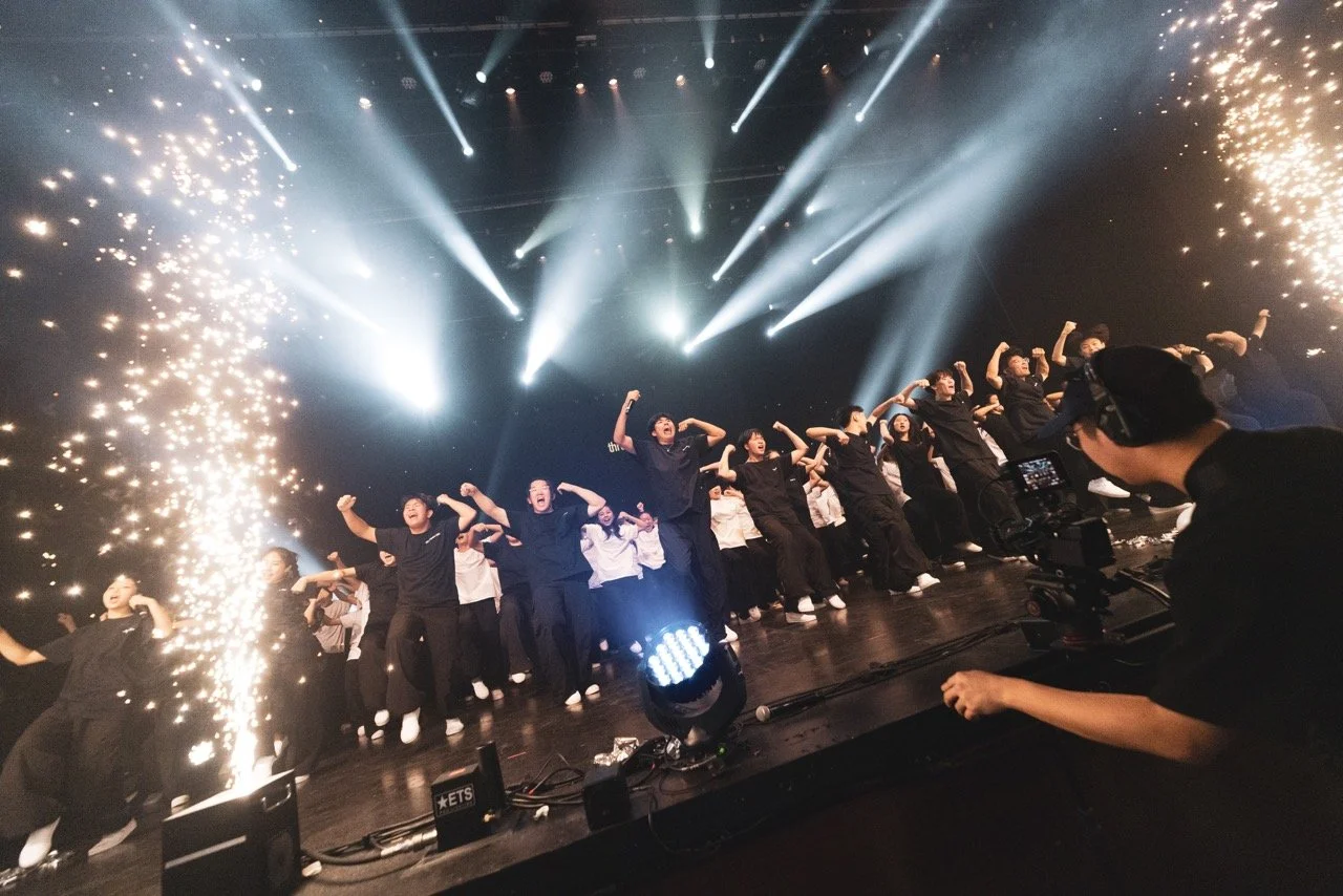 Group of performers dancing on stage with bright lights and pyrotechnics. Kids are dancing on stage in La Mirada, CA for their 34th annual concert, worshipping Jesus through singing and dance. La Mirada Theatre of the Performing Arts.