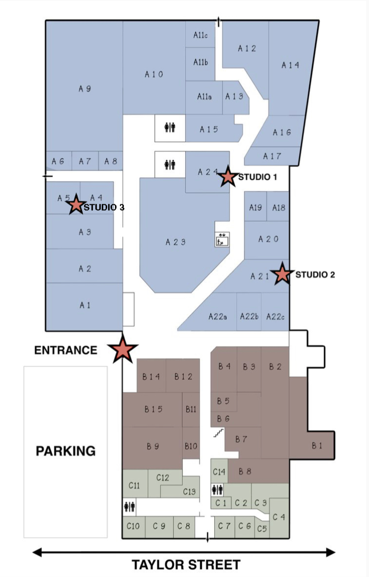 Floor plan layout with labeled rooms, three starred studio locations, a parking area, and restrooms at the bottom.