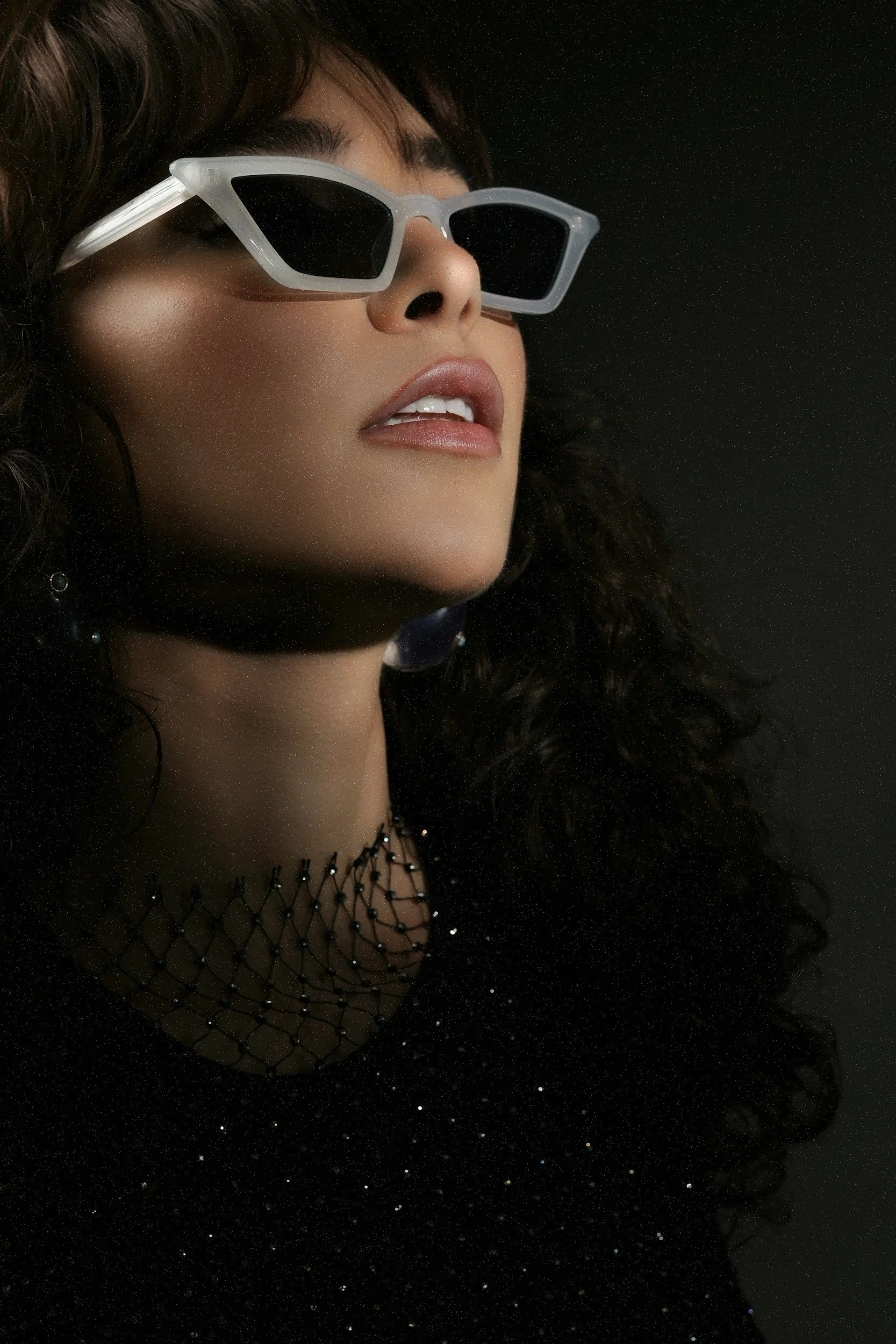 female with sunglasses appearing to look far away and focused.  used to symbolize hypnotherapy
