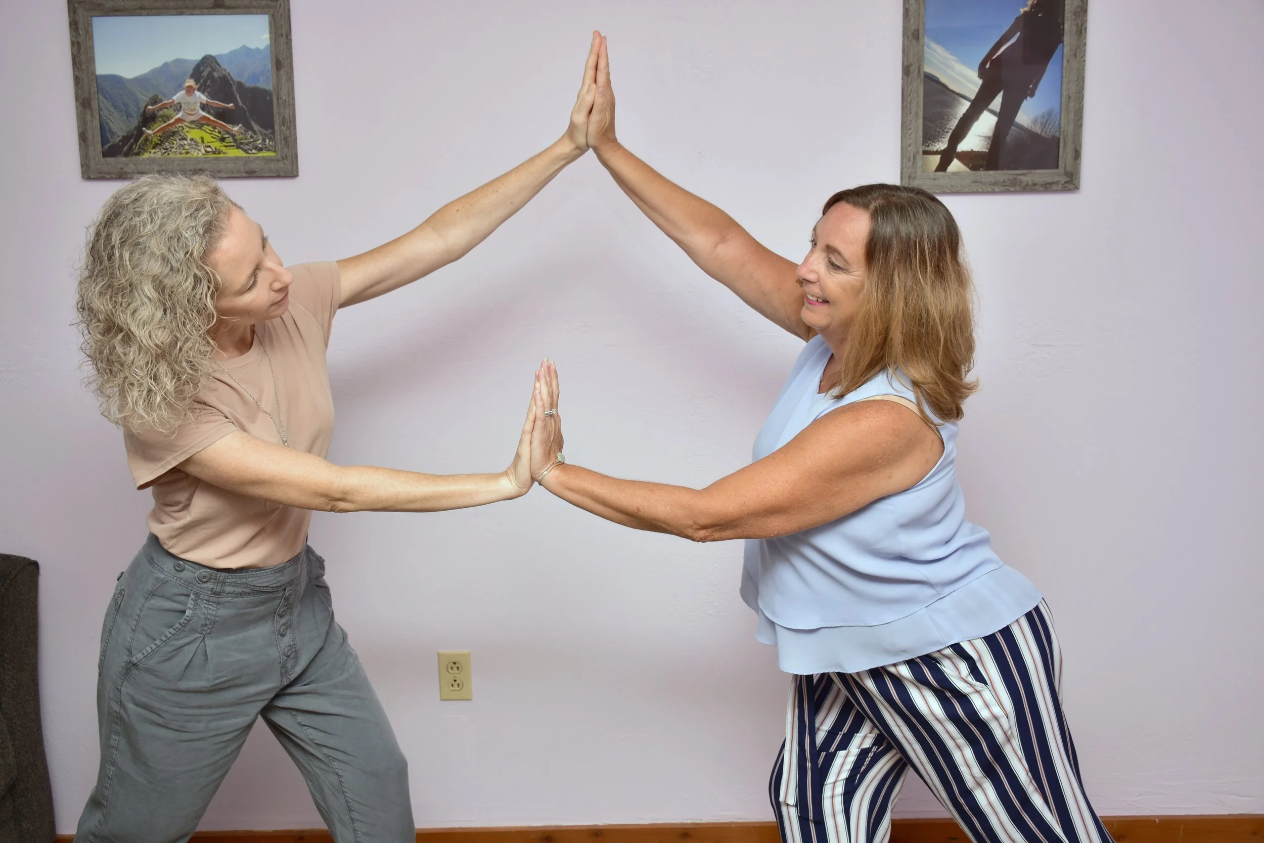 Melissa with a woman pushing against each other as an example of dance/movement therapy