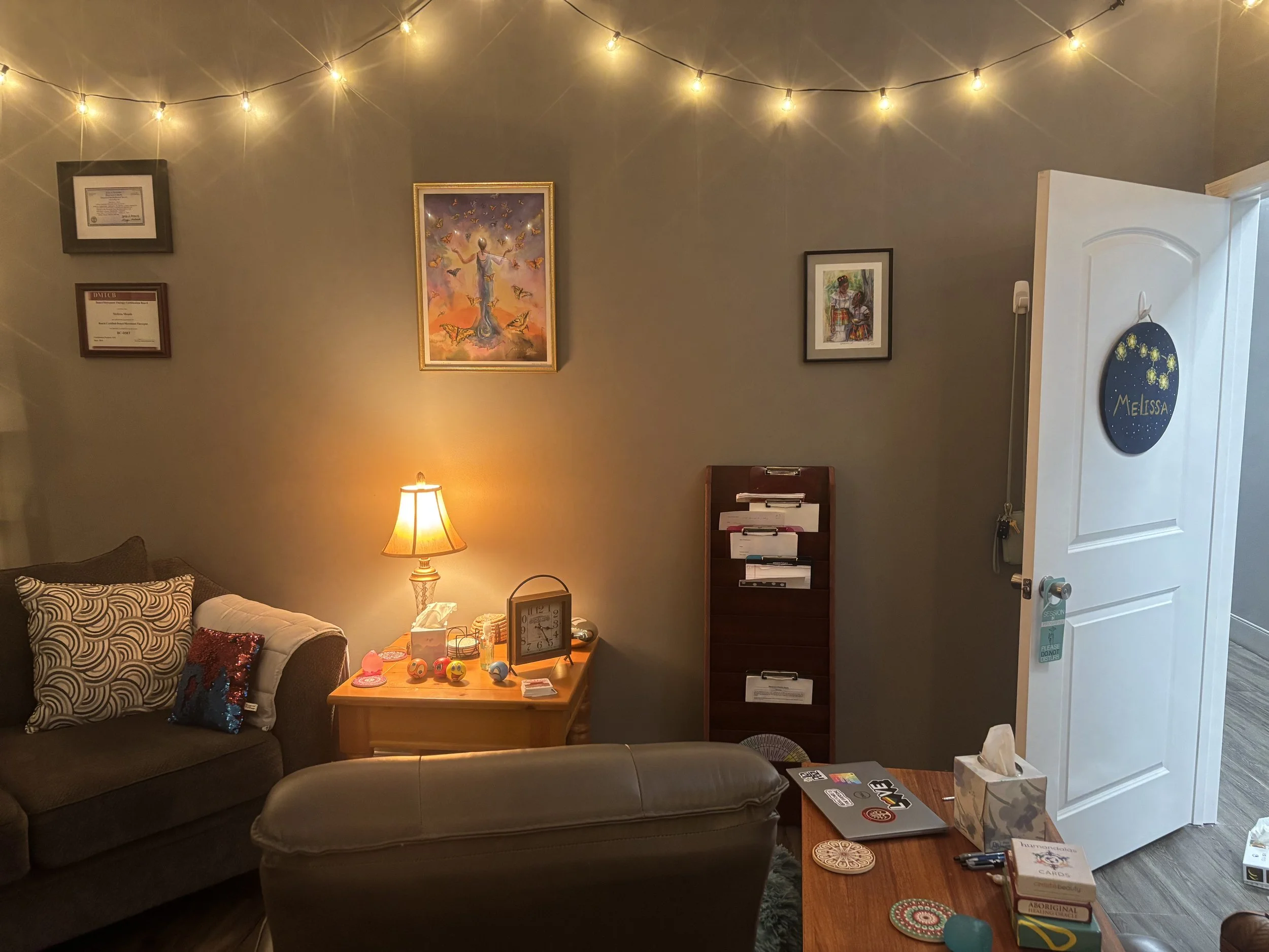 Melissa's office including loveseat, chair, table and soft lighting