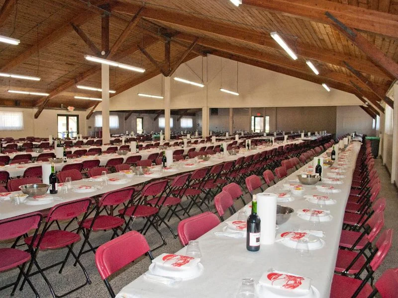 Back Hall banquet hall setup at the FDES Portuguese Hall of Monterey with long dining tables and reception seating.