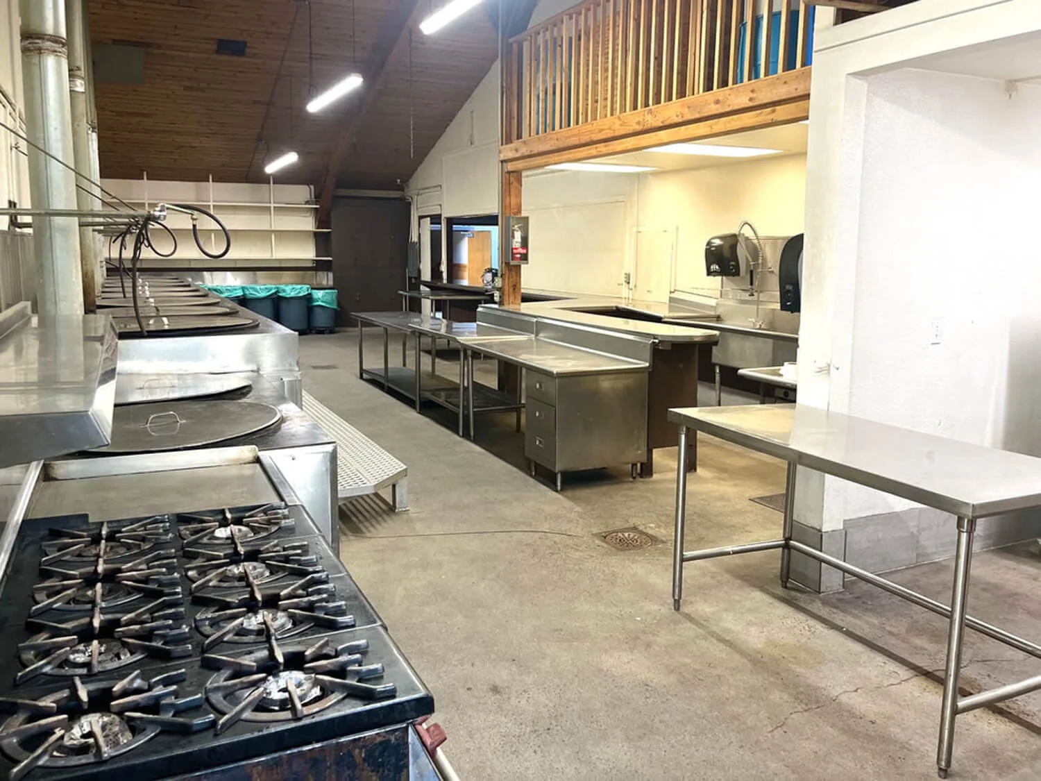 Back Hall on-site catering kitchen at the FDES Portuguese Hall of Monterey with prep tables, range, and staging space.