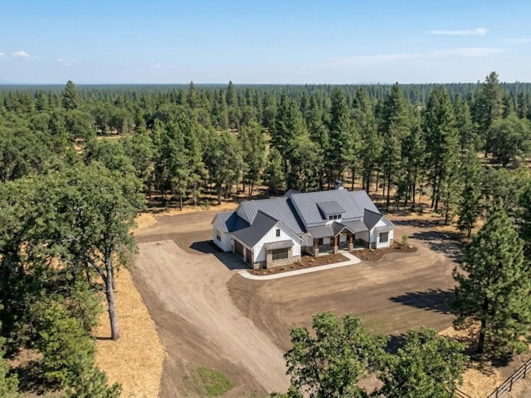 Heavy equipment performing professional land grading, dirt work, and site preparation for a property in Collierville, Tennessee.