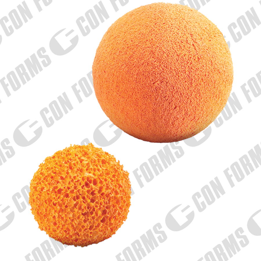 Two concrete pumping cleanout sponge balls, one large and round with a textured surface, and a smaller, porous sponge, both in shades of orange.