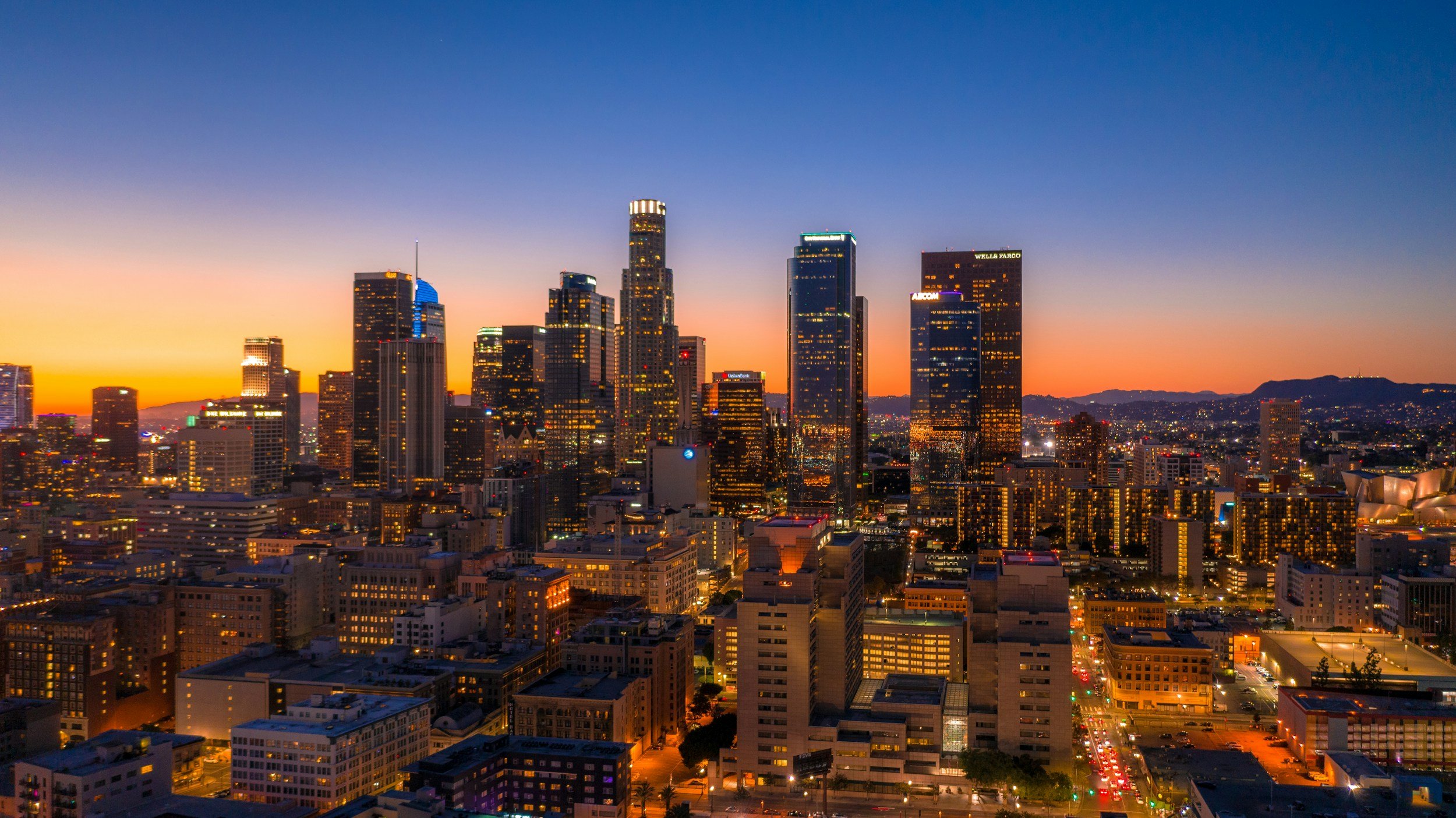 Los Angeles city skyline at sunset with tall skyscrapers and colorful sky