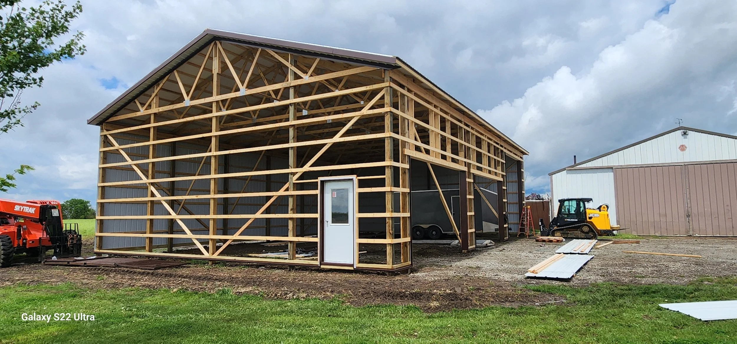 Pole barn half built showing framing and siding.jpg