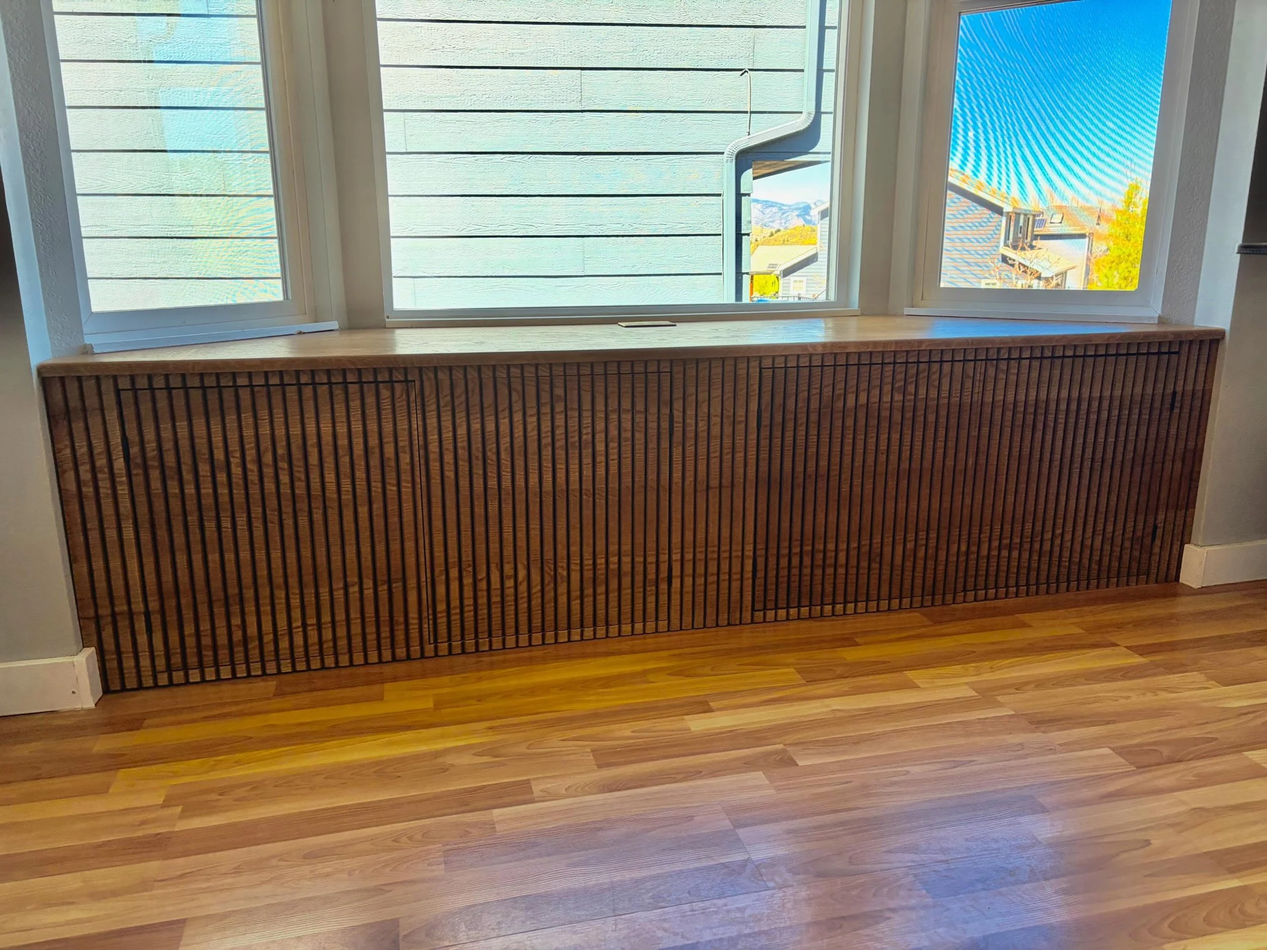 Is there a bay window in your house? Are you unsure what to do with the space? Build a bench with storage space! This one is built with white oak, and the face of the bench is fluted. When the doors are closed, you can barely even tell that they are 