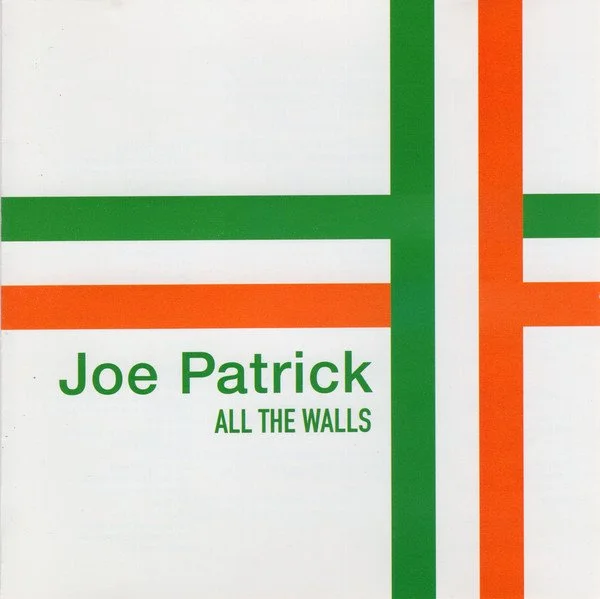 Album cover for Joe Patrick's "All the Walls" featuring green and orange horizontal and vertical lines.