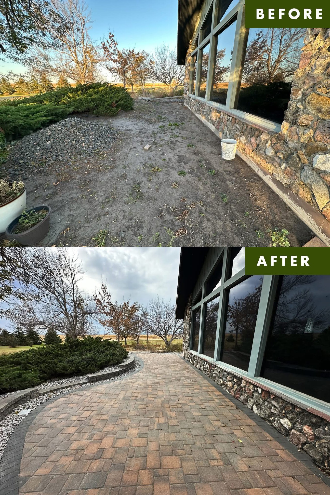 Before and after images of an outdoor patio area. The 'before' photo shows a dirt surface with some plants and a pile of gravel near a stone wall, with trees and open land in the background. The 'after' photo shows the same area paved with interlocki