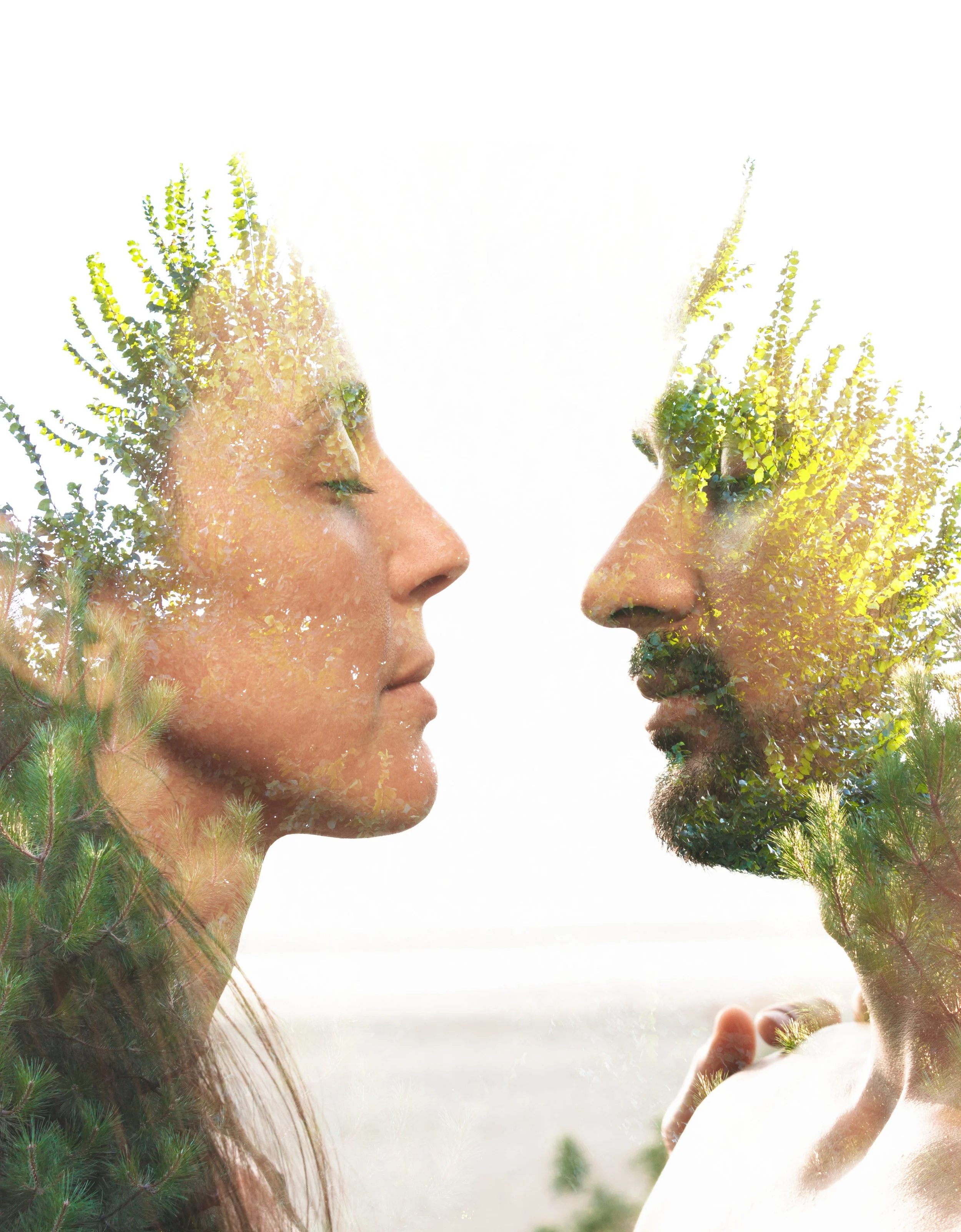 Double exposure of a woman and a man with closed eyes, facing each other, overlaid with trees and nature, creating an artistic and serene effect.