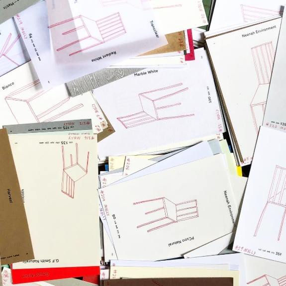 A collection of small hand-drawn sketches of chairs arranged loosely across a page in an informal, haphazard layout.