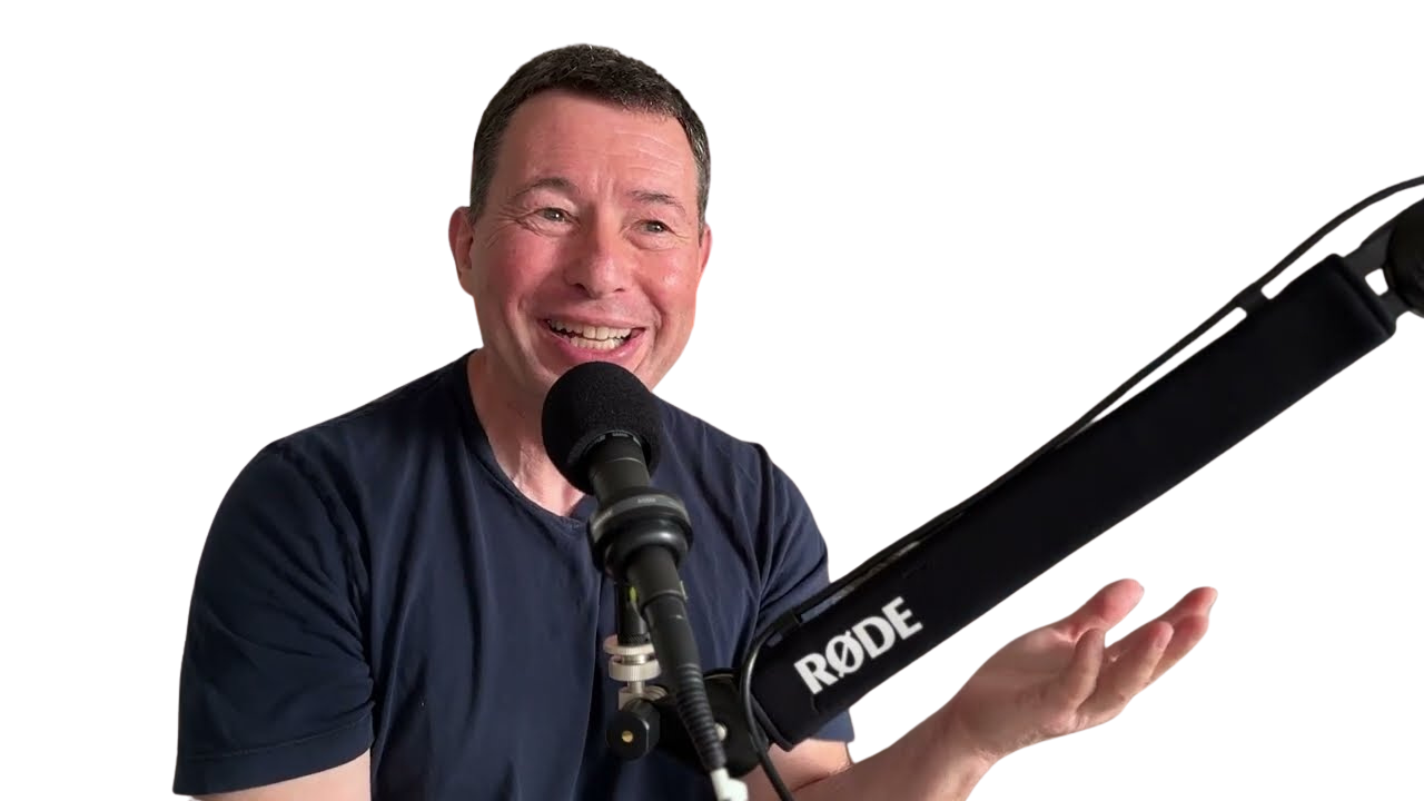 Smiling man speaking into a microphone with a RODE microphone attached, with colorful graphic lines on a dark background.