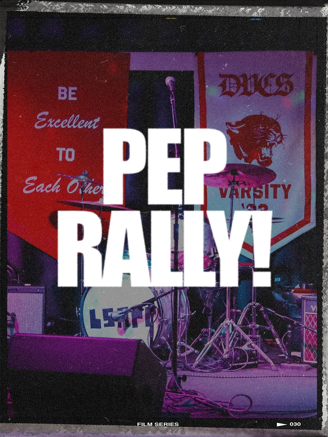 Film frame of an empty stage with a "PEP RALLY" text overlay