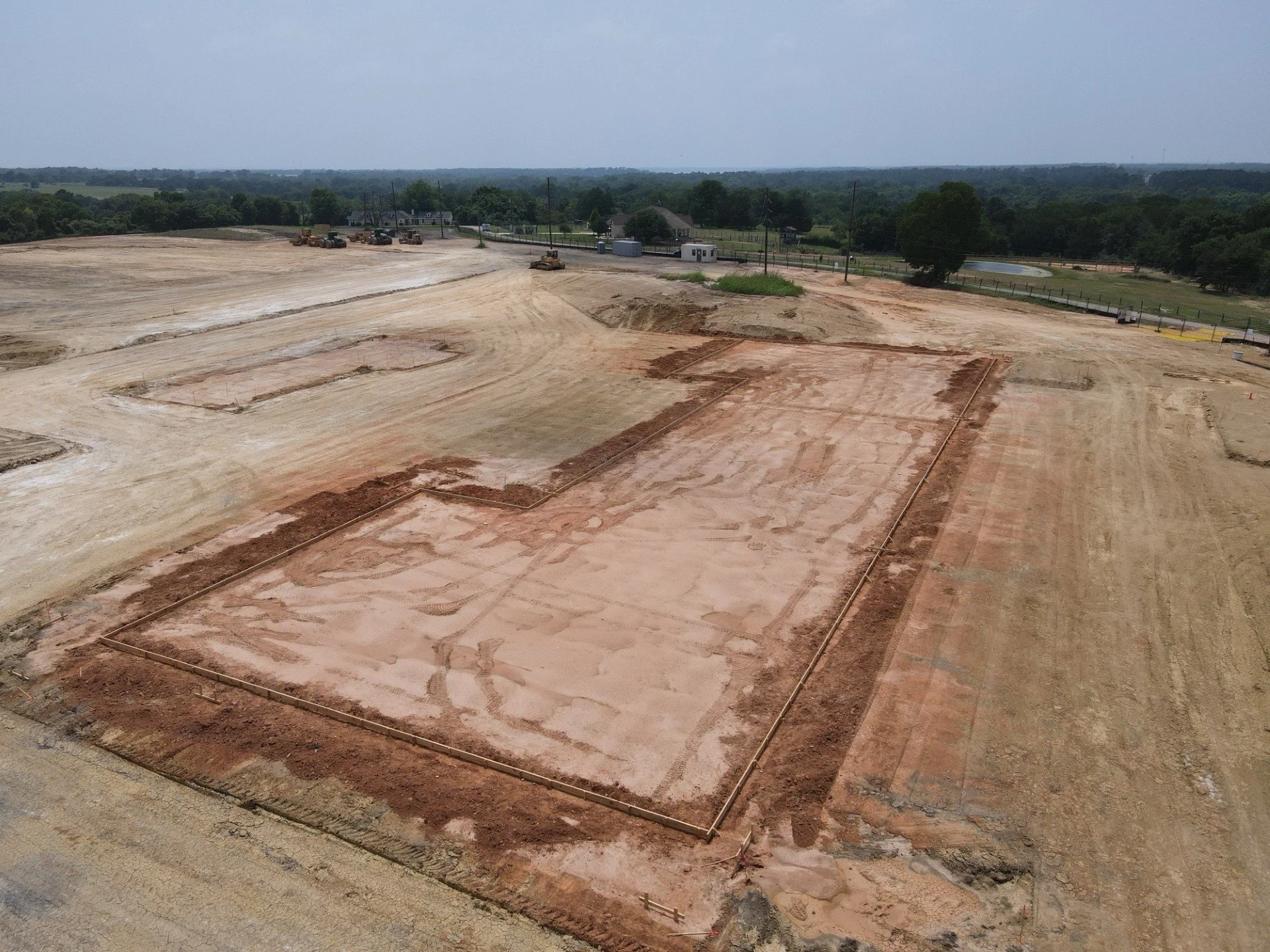 Site preparation and building pad excavation in Conroe showing leveled foundation area for new construction project