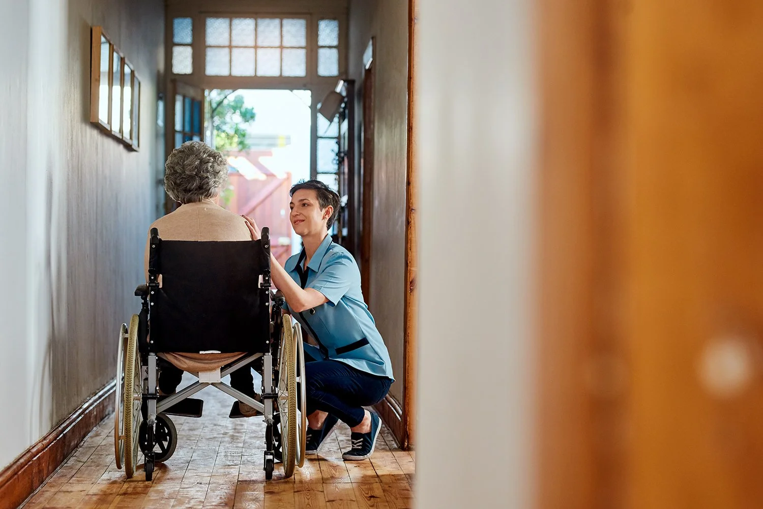 Health Care worker with Home Resident in wheelchair