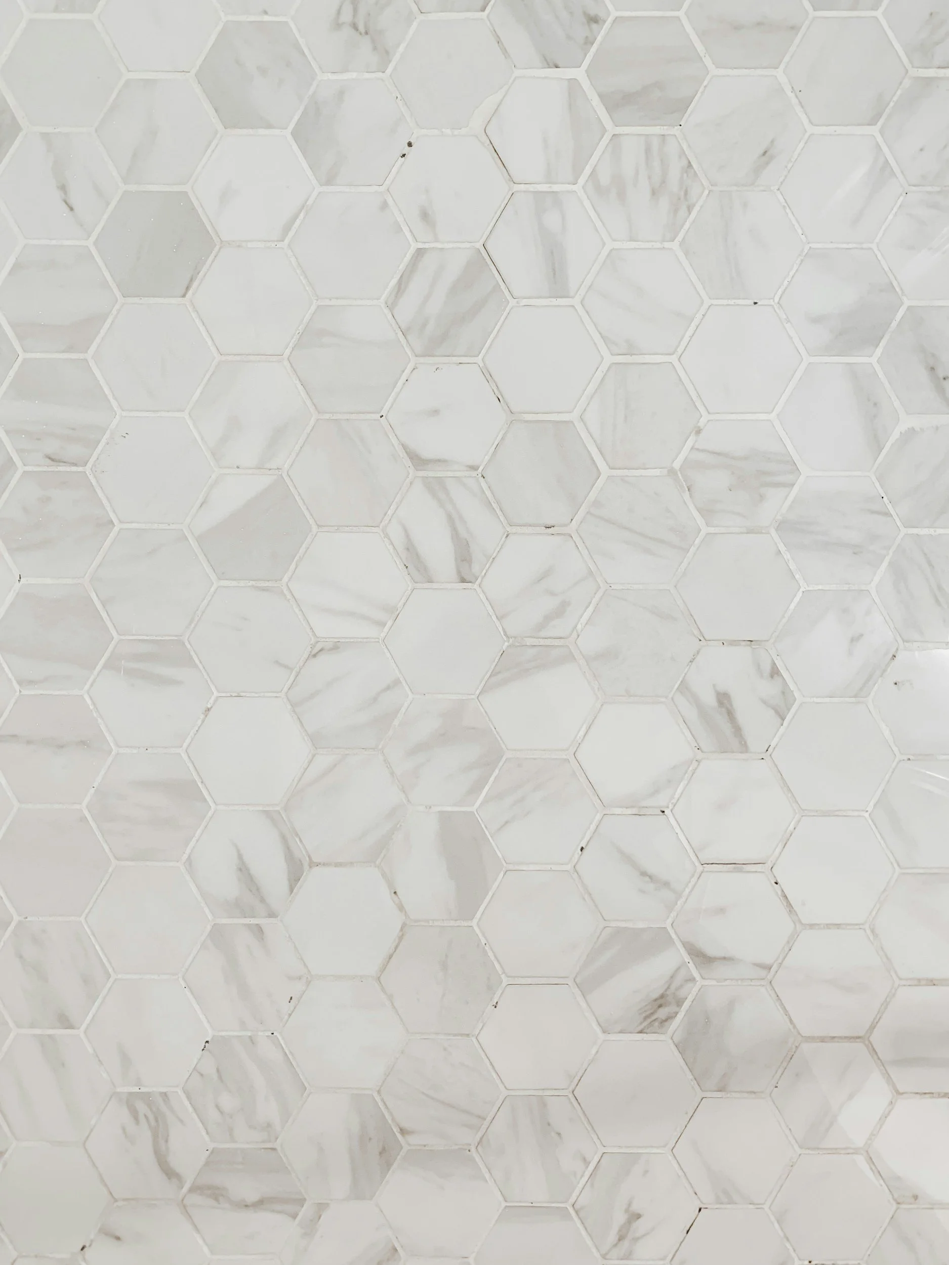 White marble hexagonal tiles on a wall or floor.