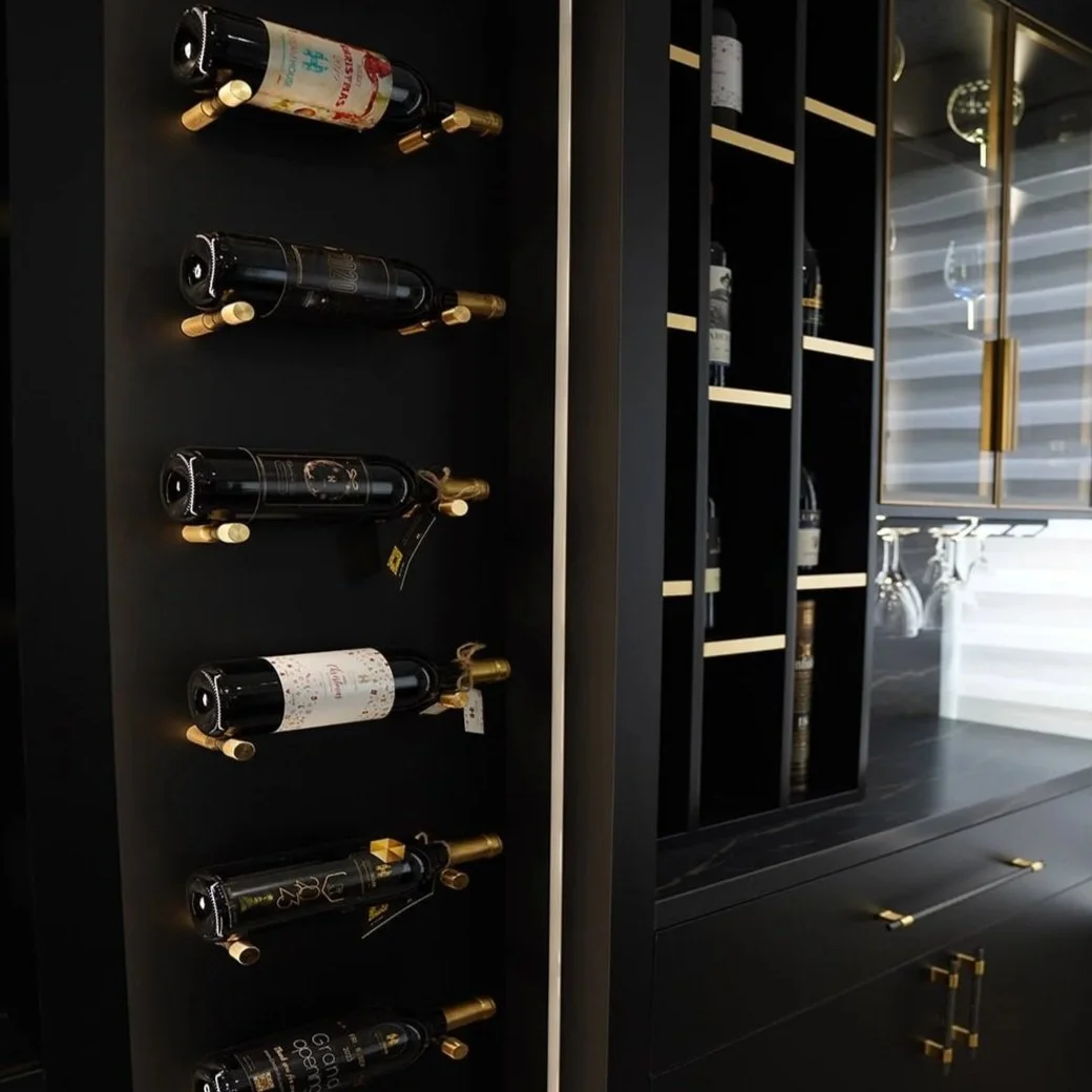 Black wine rack and storage cabinet with bottles and glasses.