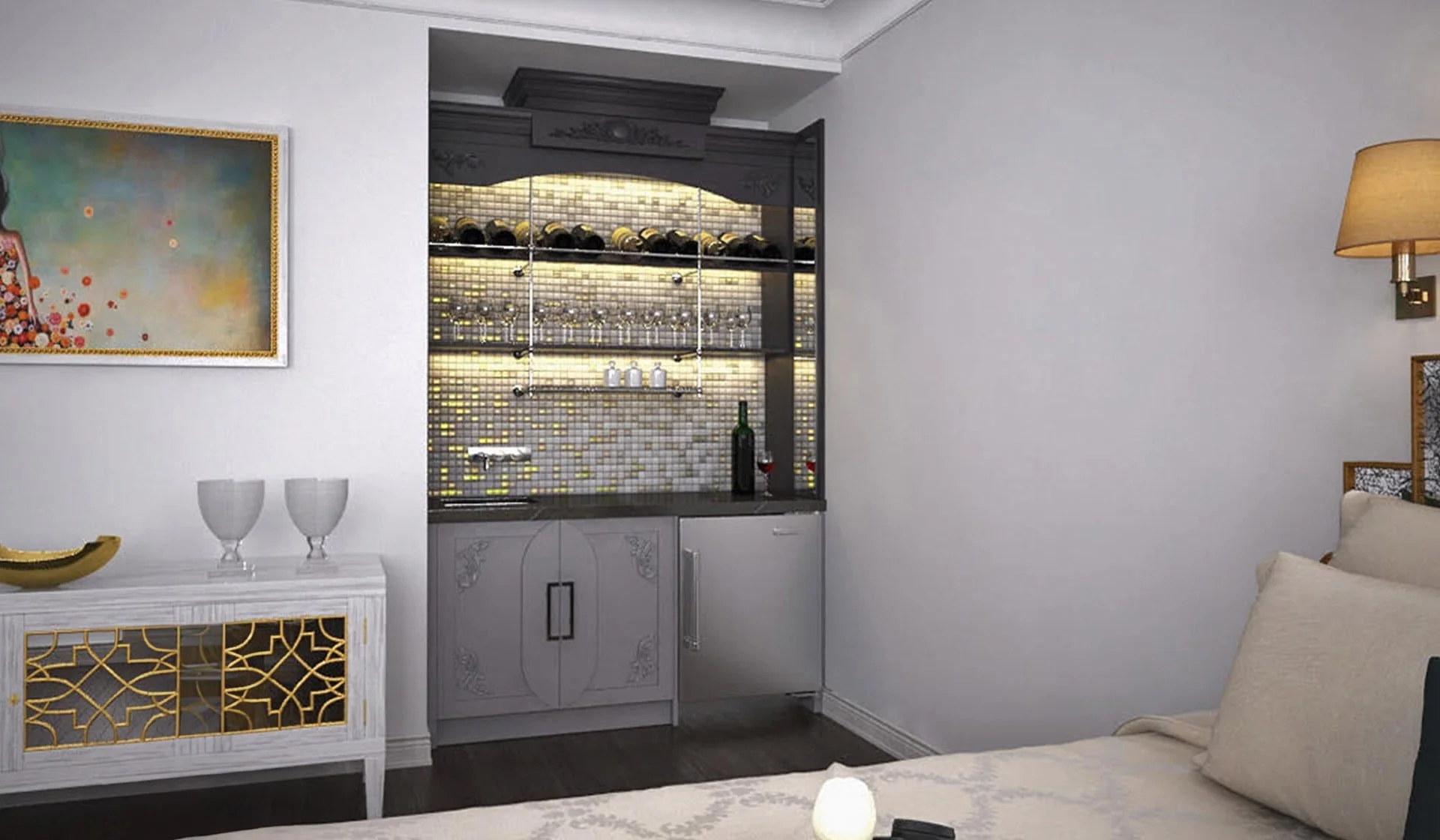 Living room corner with a white cabinet with gold accents, two wine glasses on top, a colorful abstract painting on the wall, and a bar area with shelves of wine bottles and glasses, illuminated by a lamp on the wall.