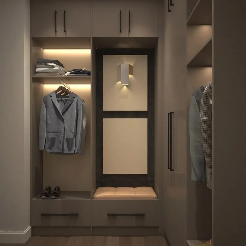 Modern walk-in closet with hanging clothes, shelves, and built-in lighting, featuring a grey blazer, shoes, and folded clothes.