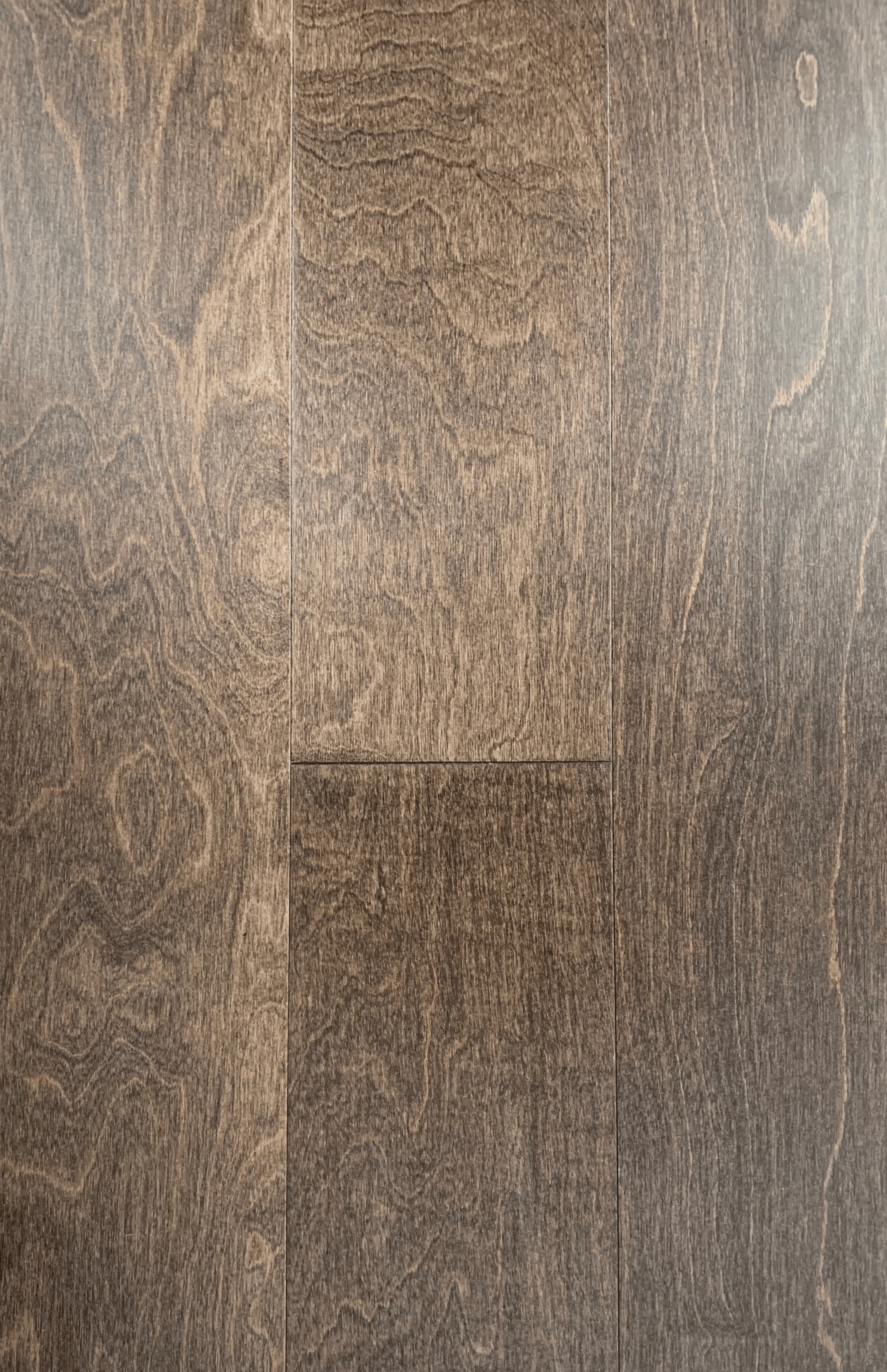 Close-up view of wooden floorboards with natural grain patterns and a medium brown finish.