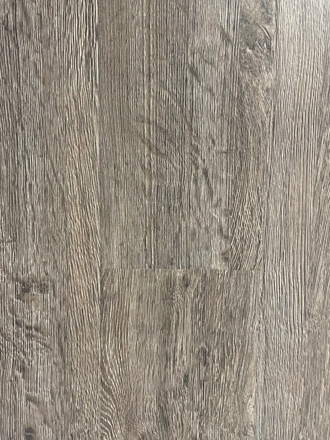 Close-up of a wooden floor with a cutout of a dog paw print.