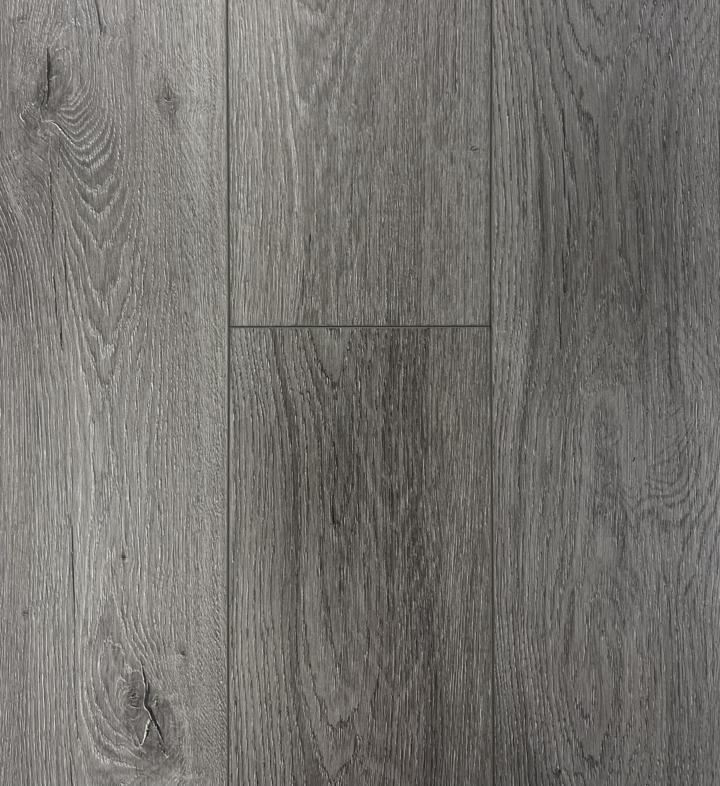 Close-up view of gray wooden floor with visible wood grain and knots.