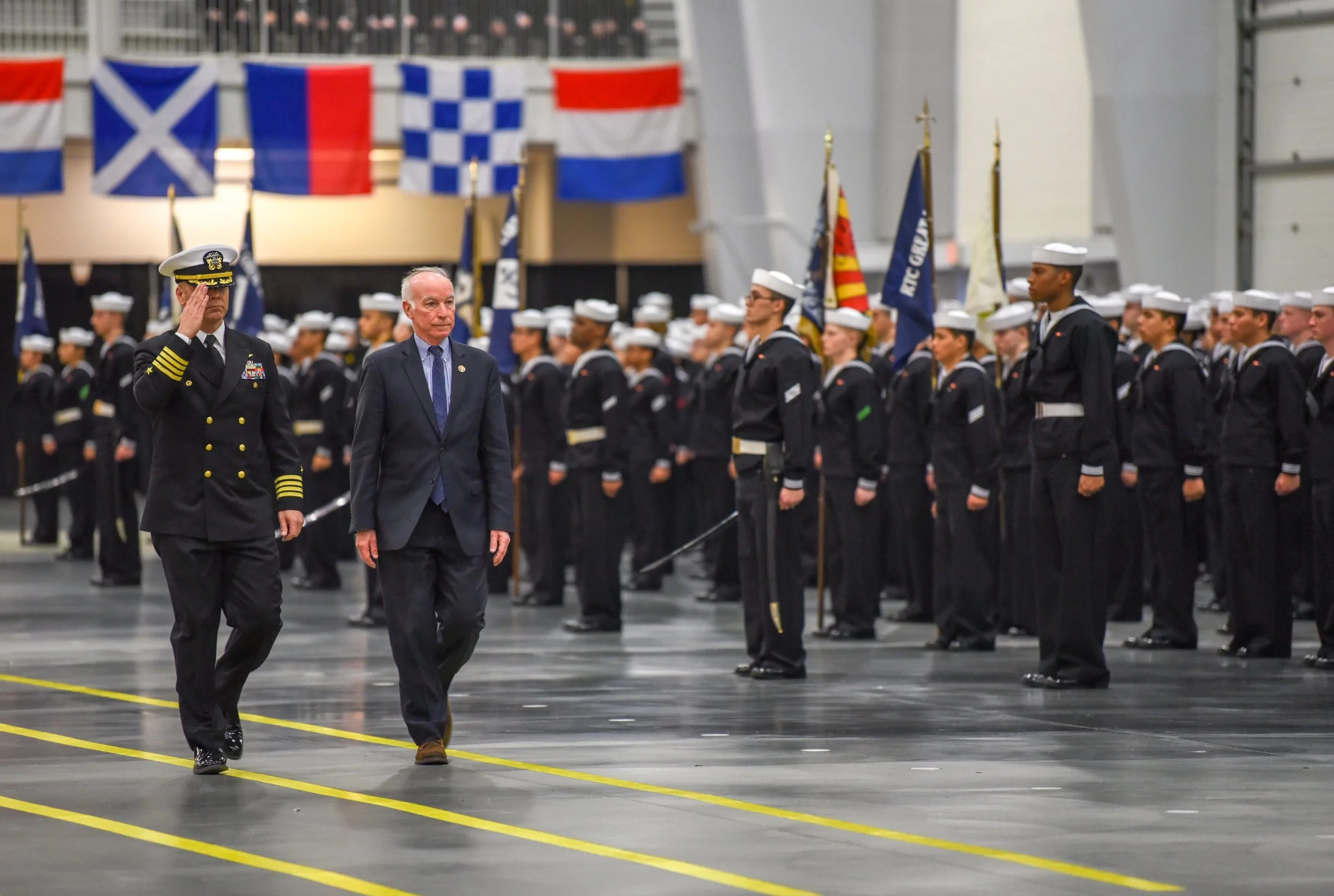 Congressman Joe Courtney, Connecticut 2nd District, and Capt. Erik Thors, commanding officer, Recruit Training Command (RTC) receive salutes from the graduating divisions during a pass-in-review graduation ceremony at RTC. Courtney served as the revi