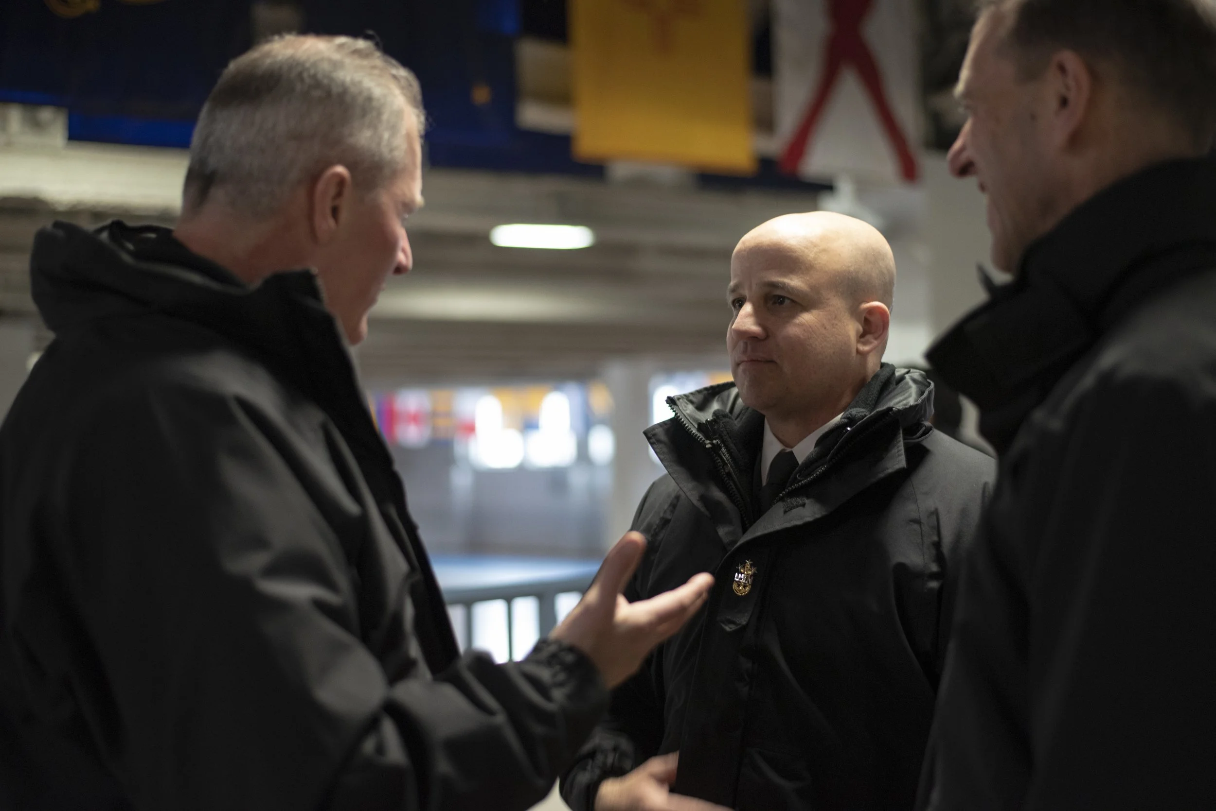 Master Chief Petty Officer of the Navy (MCPON) Russell Smith speaks with Rear Adm. Mike Bernacchi, commander, Naval Service Training Command, inside Freedom Hall at Recruit Training Command (RTC). The MCPON is visiting RTC, the Navy's only boot camp,