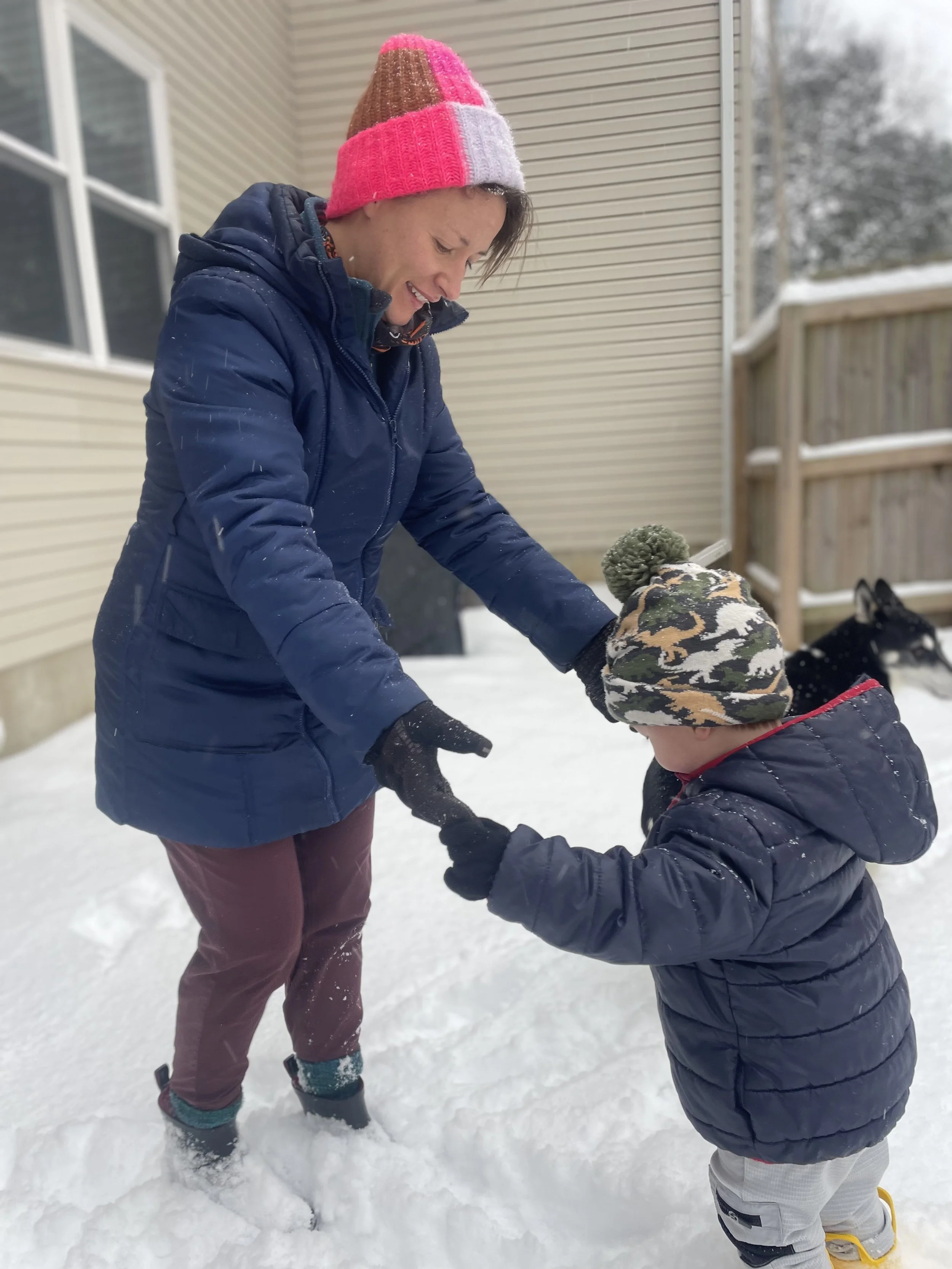 Mandy and her son playing in the snow