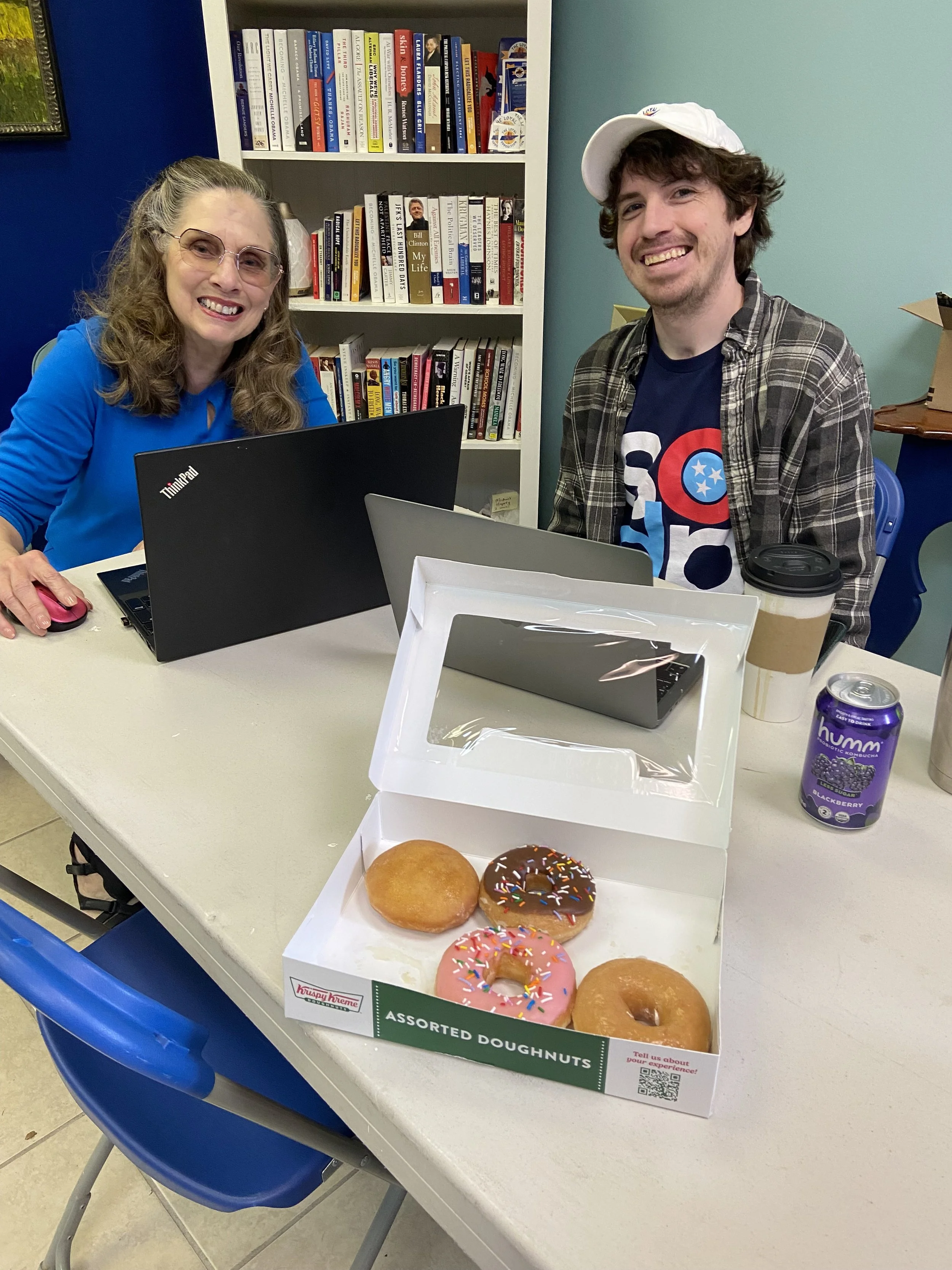 Two volunteers working at a table
