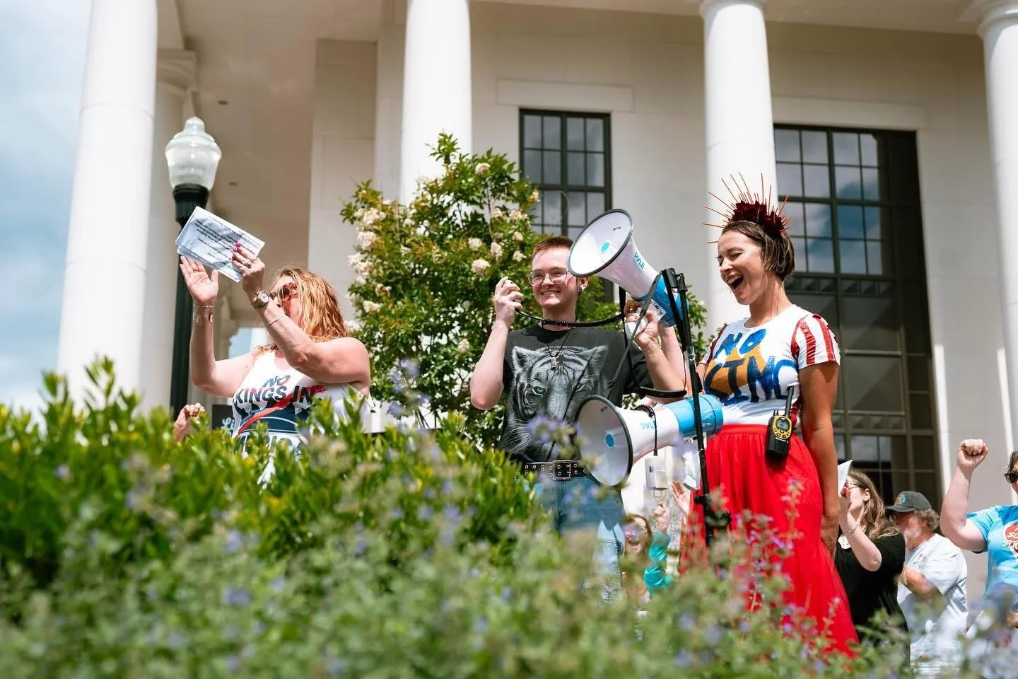 Mandy and friends smiling at a No Kings rally