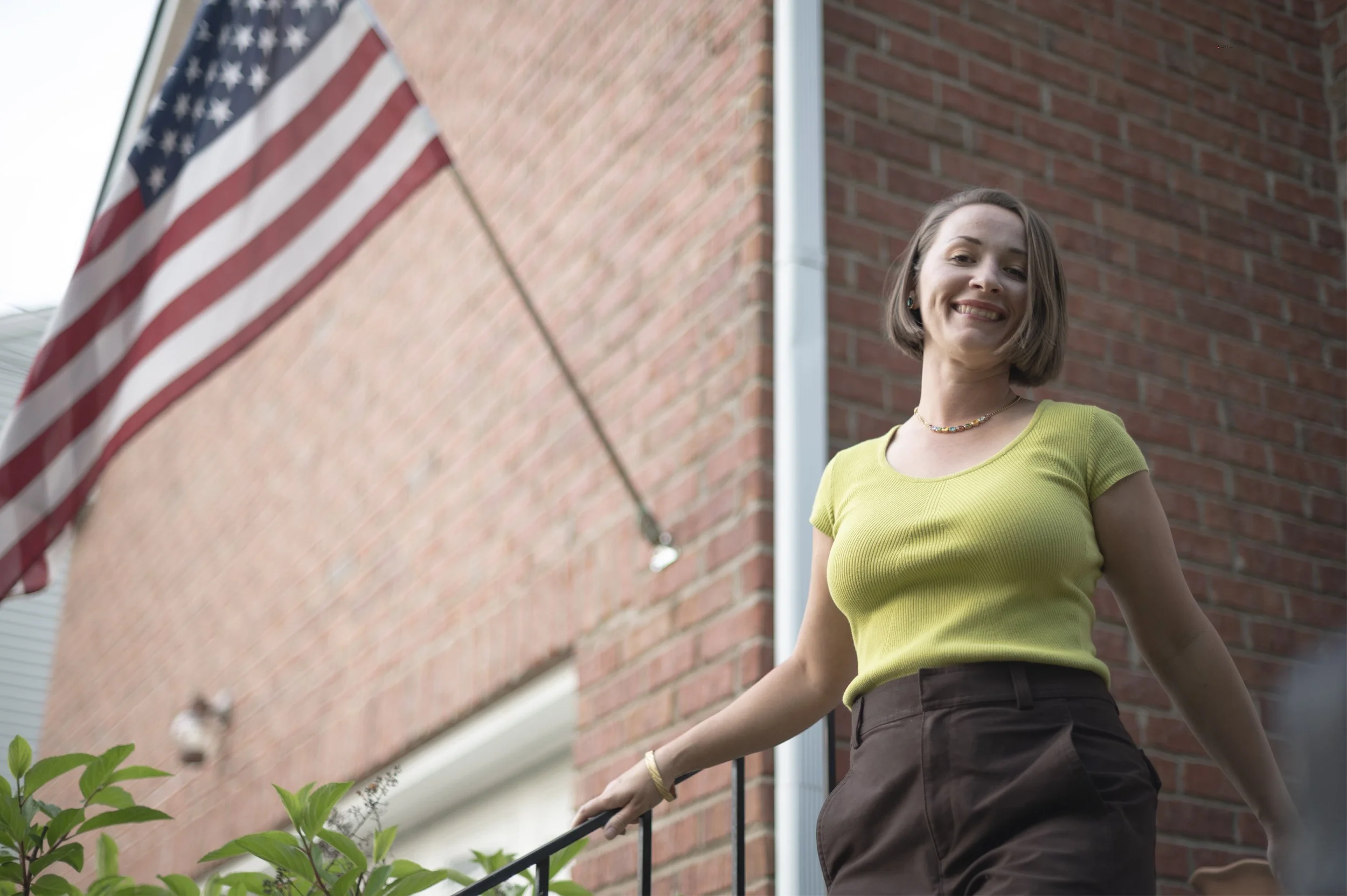 Mandy standing before an American flag